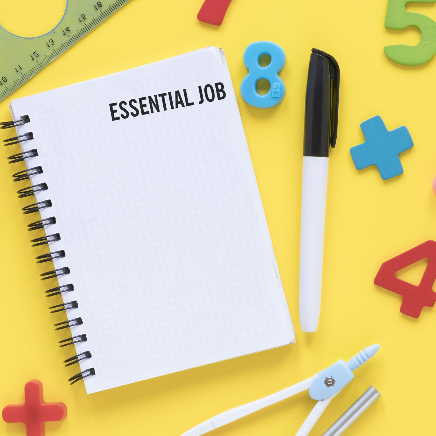 Essential job notebook surrounded by colorful school supplies on a yellow background, with numbers and a pen for education or classroom concept.