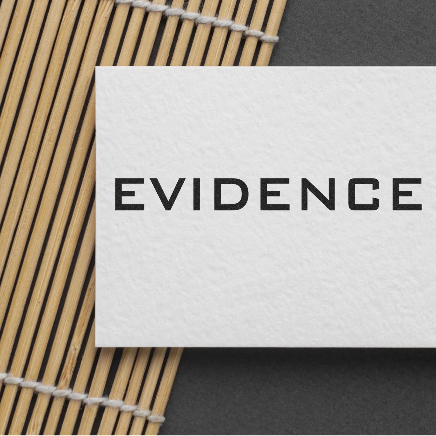 Evidence word card on woven bamboo placemat, styled as a legal proof and investigation documentation background for blog and study articles.