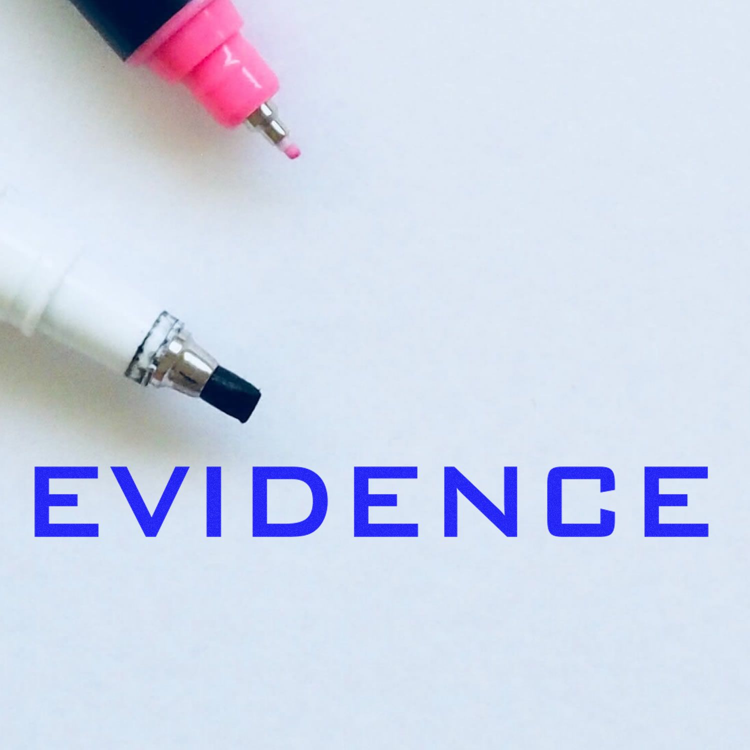 Pink and black pen tips on white paper with the word EVIDENCE in bold blue text.