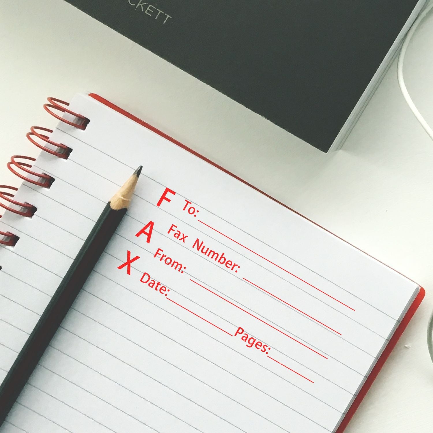 Open notebook with pencil and fax cover sheet form on a desk, office stationery and business communication concept