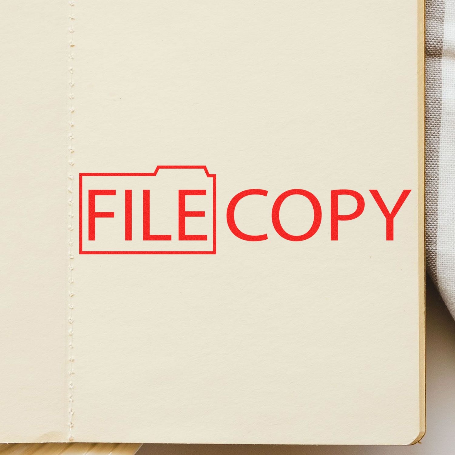 Red FILE COPY stamp on a blank notebook page with folder icon, office document archive concept