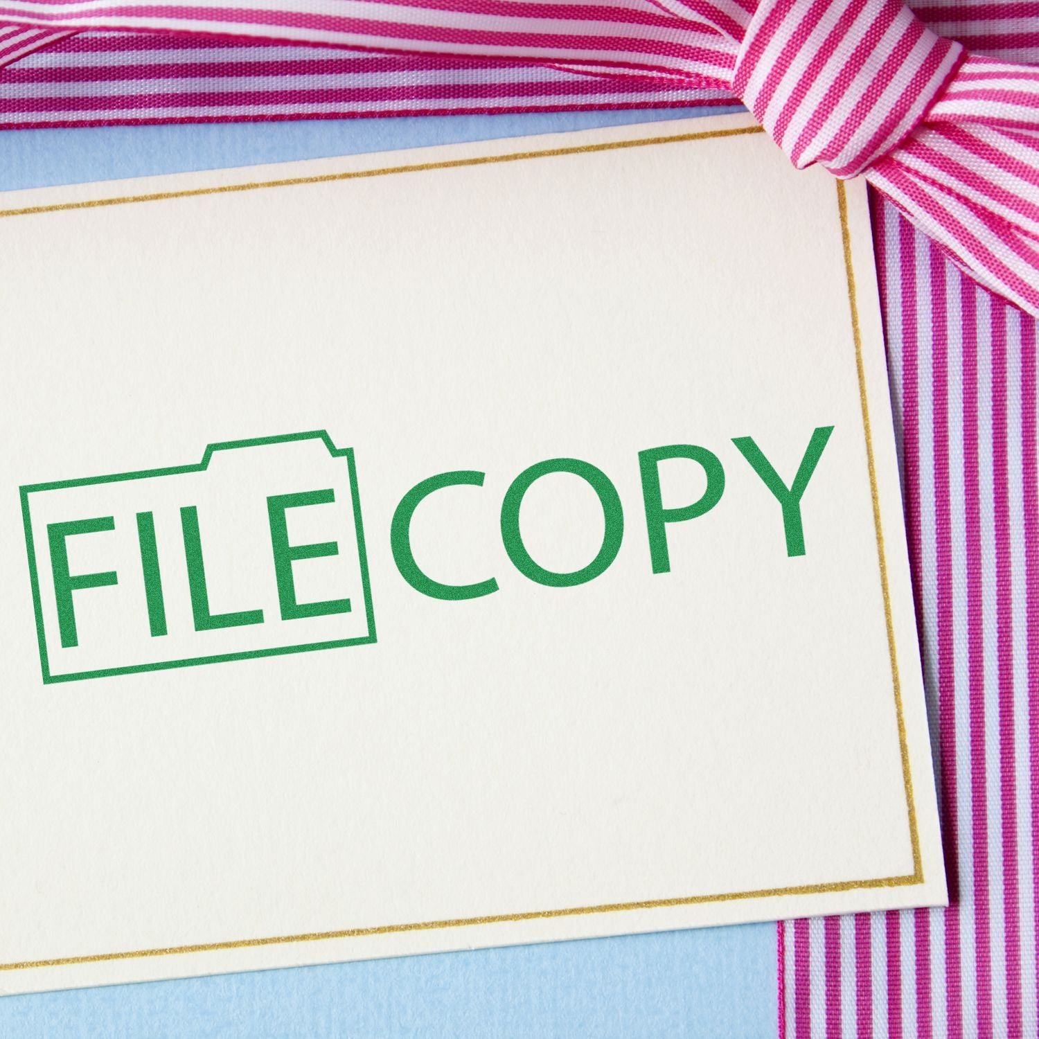 Close-up of a FILE COPY label on a white document, showing office file-copy branding against striped fabricgreat for document templates.