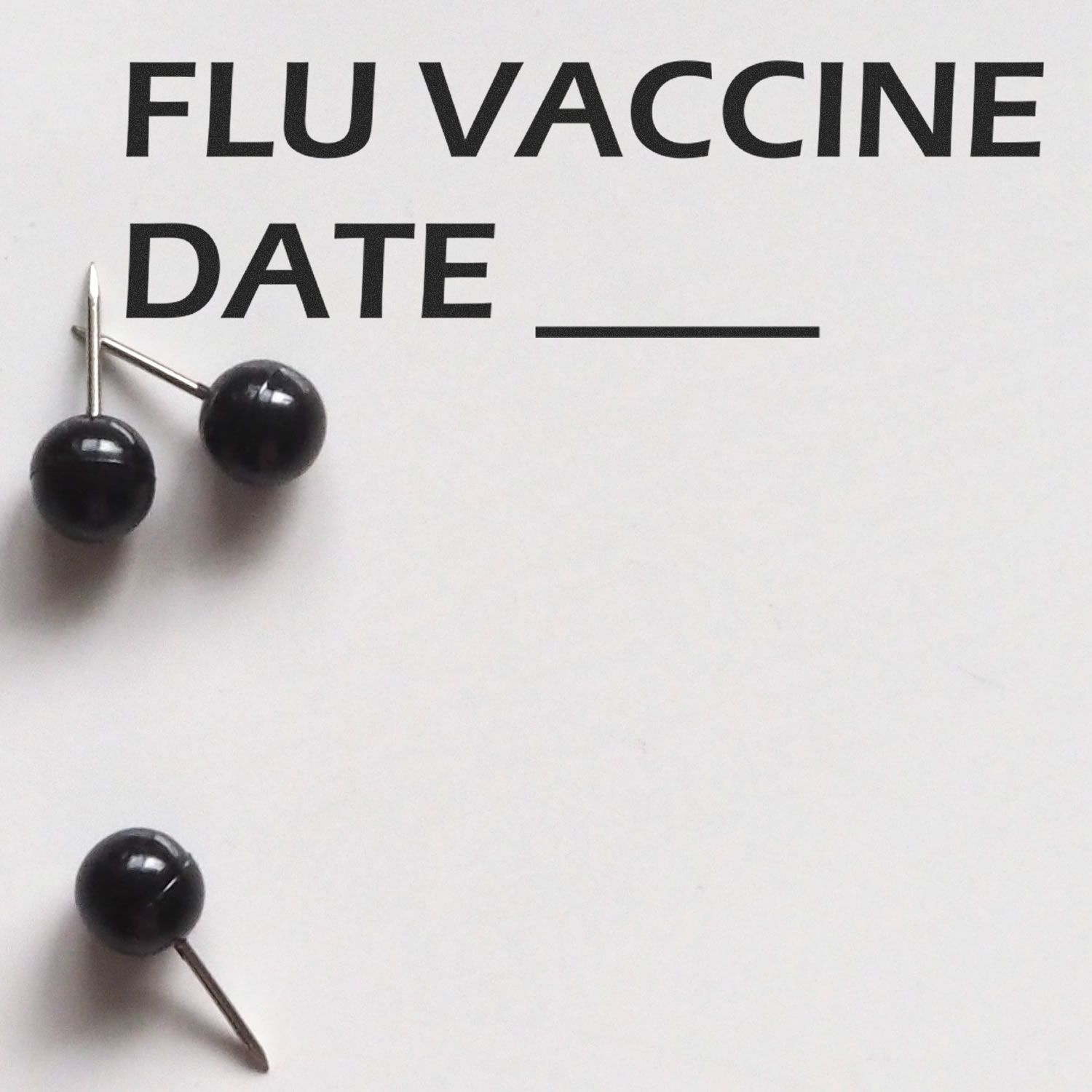 Flu vaccine date reminder with medical pushpins on FLU VACCINE DATE text for seasonal influenza immunization scheduling.