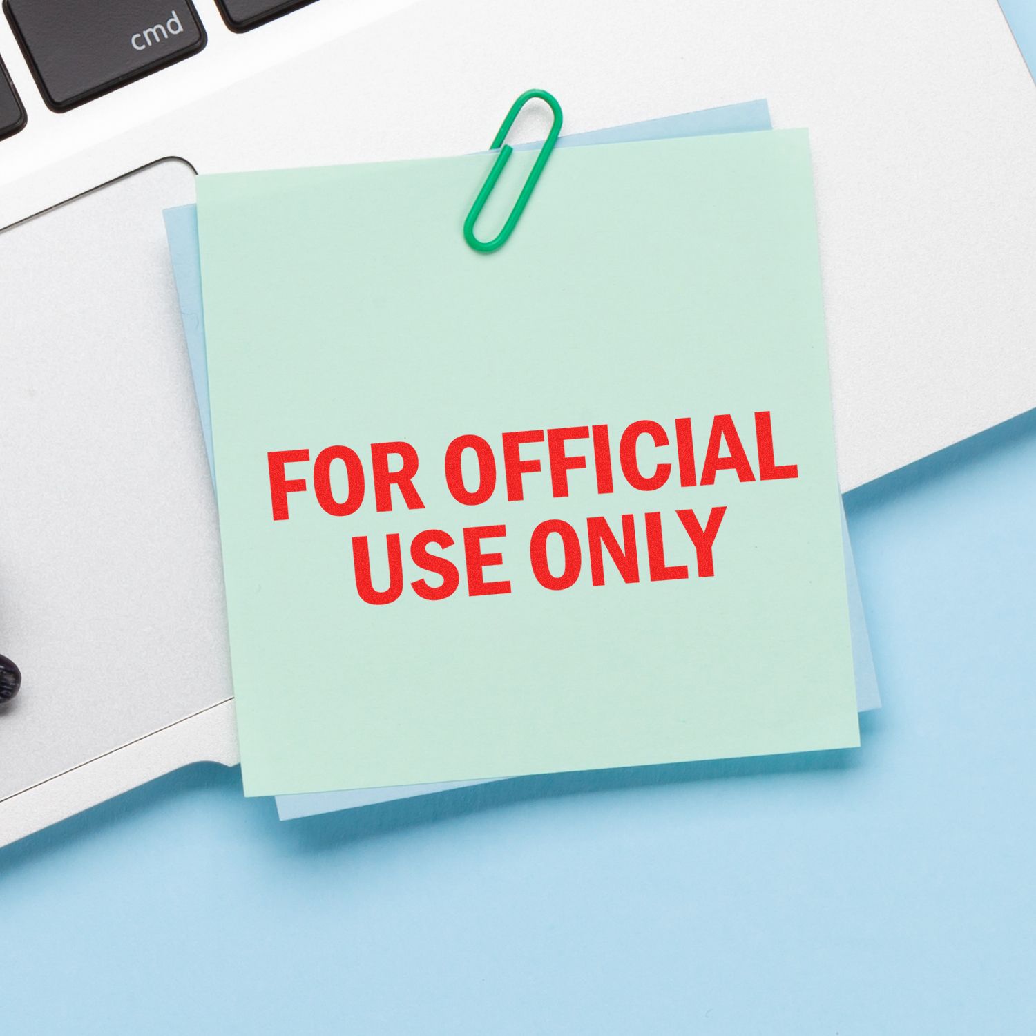 Sticky note with For Official Use Only text clipped to office papers on a desk, business document security concept.