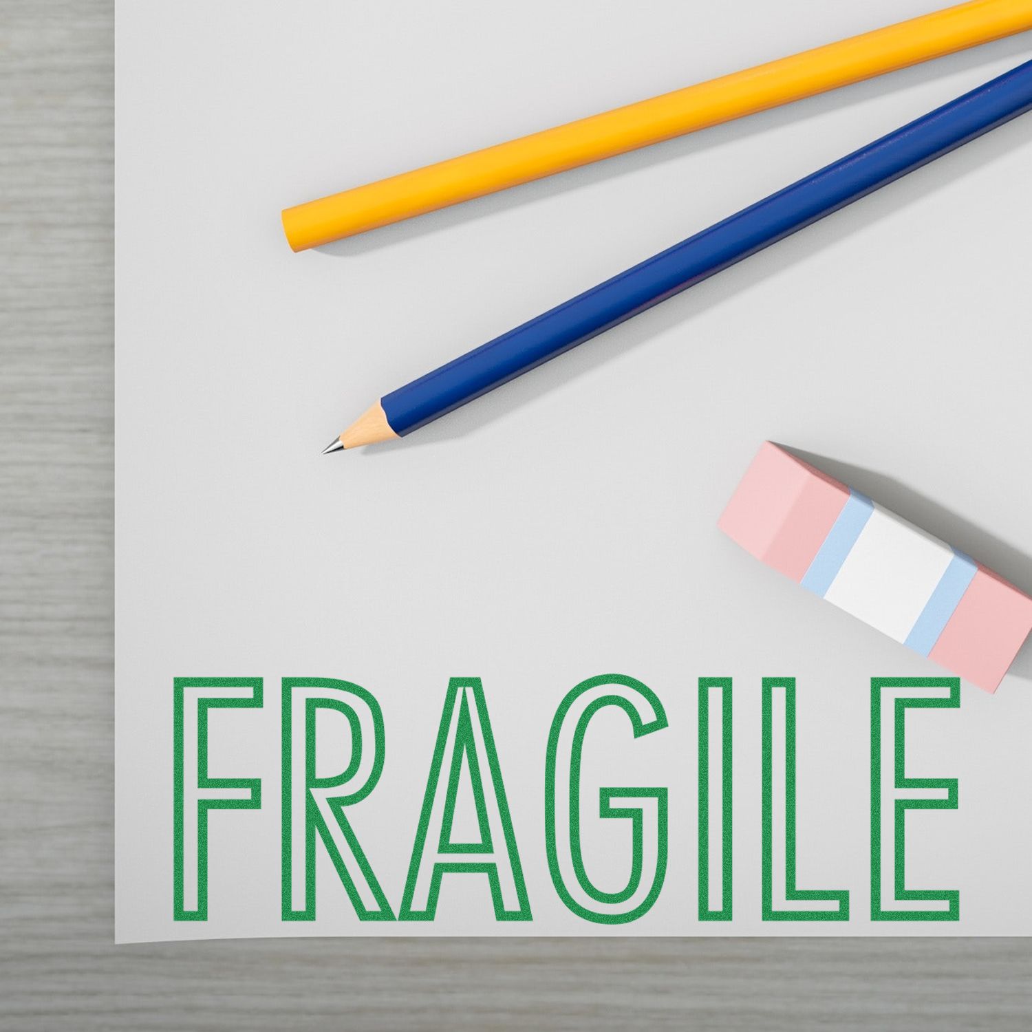 Fragile shipping label with pencil and eraser on white paper, packaging and office concept.
