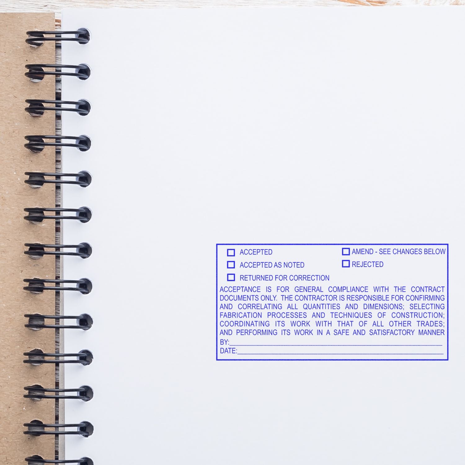 Blank spiral notebook page with blue approval stamp checklist for contract documents, accepted and rejected options, construction review form.