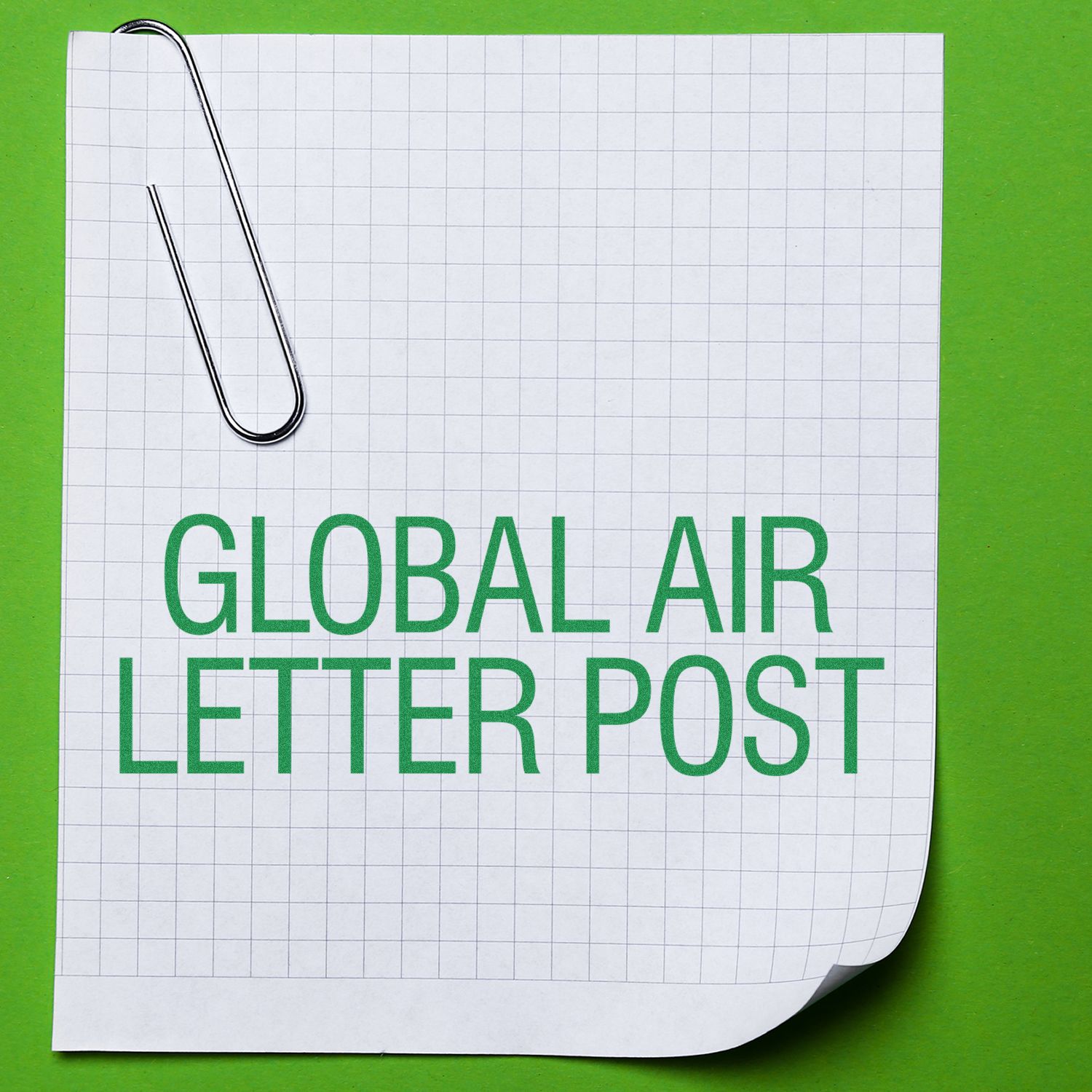 Global air letter post concept on graph paper with paperclip on green background