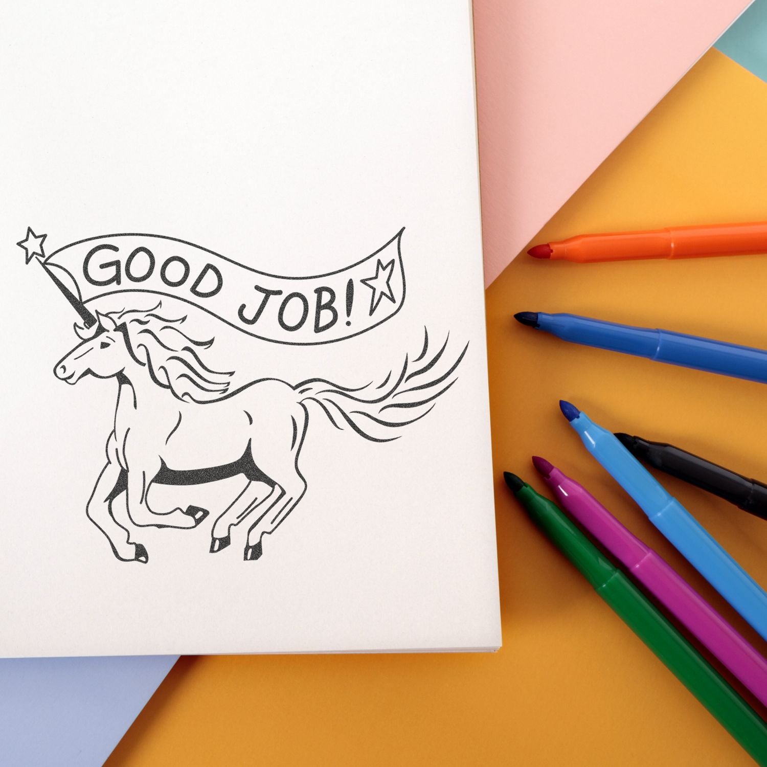 Unicorn coloring page with Good Job! banner and colorful markers on pastel background.