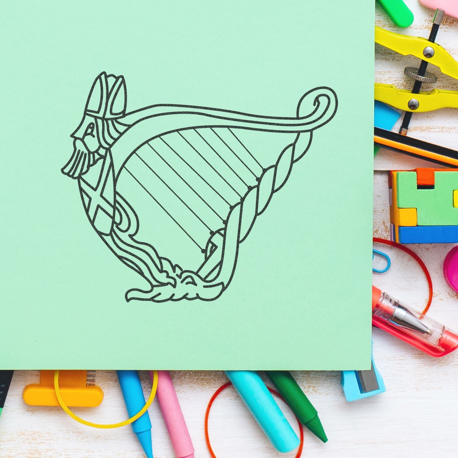 Decorative cat line art on mint green paper surrounded by colorful stationery and school supplies.