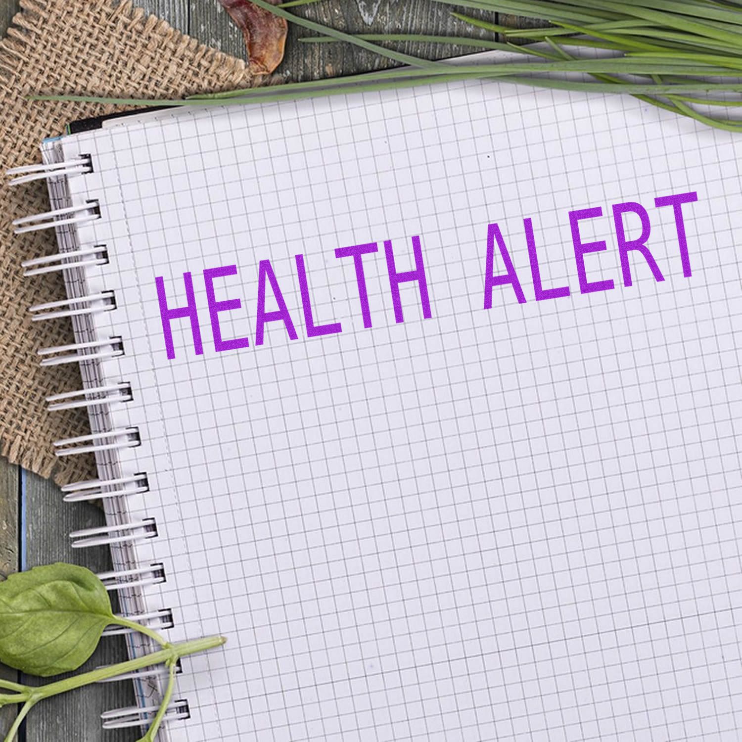 Health alert message on lined notebook with grid paper, fresh green leaves and rustic background for wellness awareness campaign.