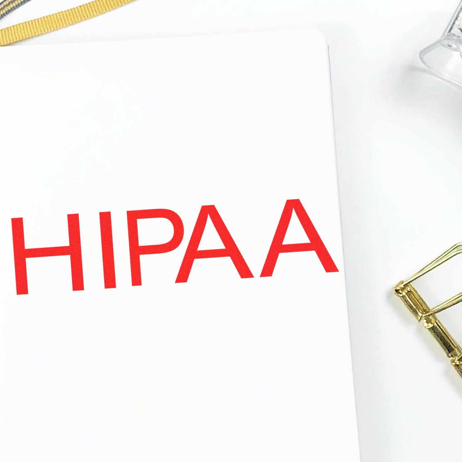 HIPAA compliance document on white clipboard with red text close-up