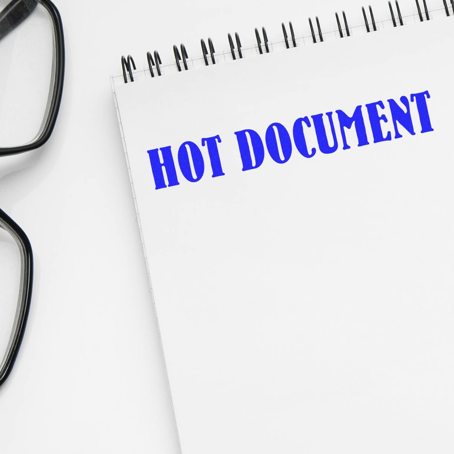 Hot document label on a business file page with binder clips, indicating urgent paperwork and confidential records management.