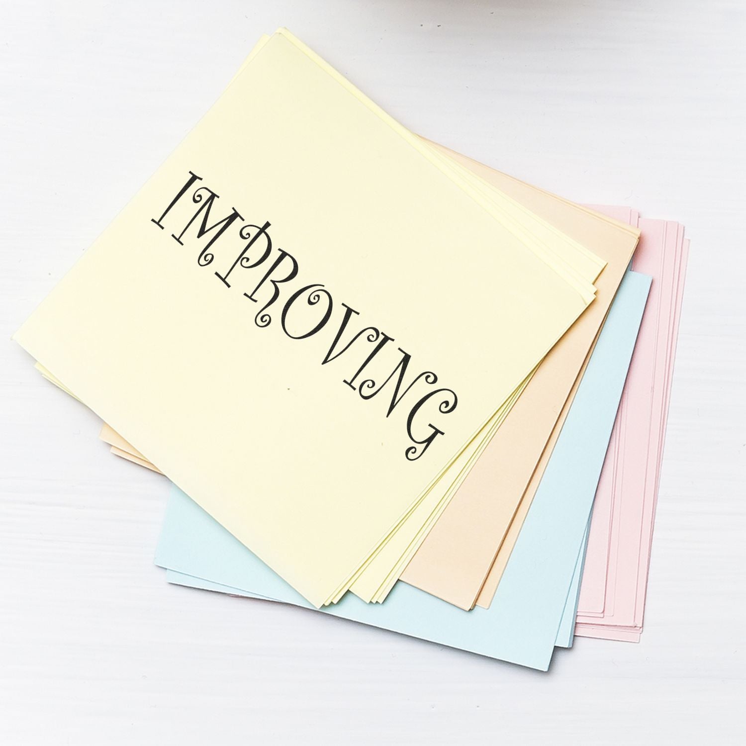 Stack of pastel greeting cards and stationery with decorative lettering for DIY invitations, cards, and paper craft projects