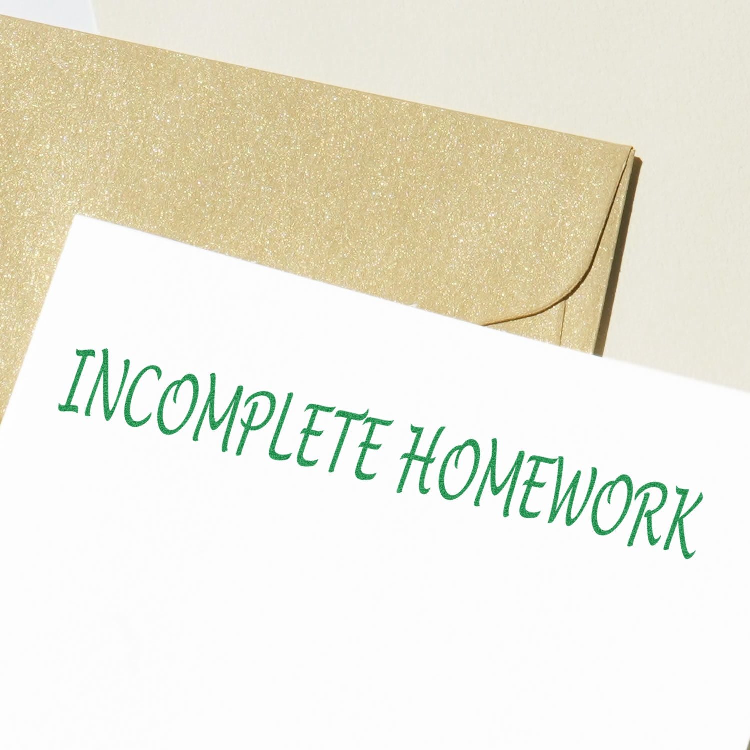 Gold glitter homework envelope with green HOMEWORK lettering for organizing and sending school assignments.