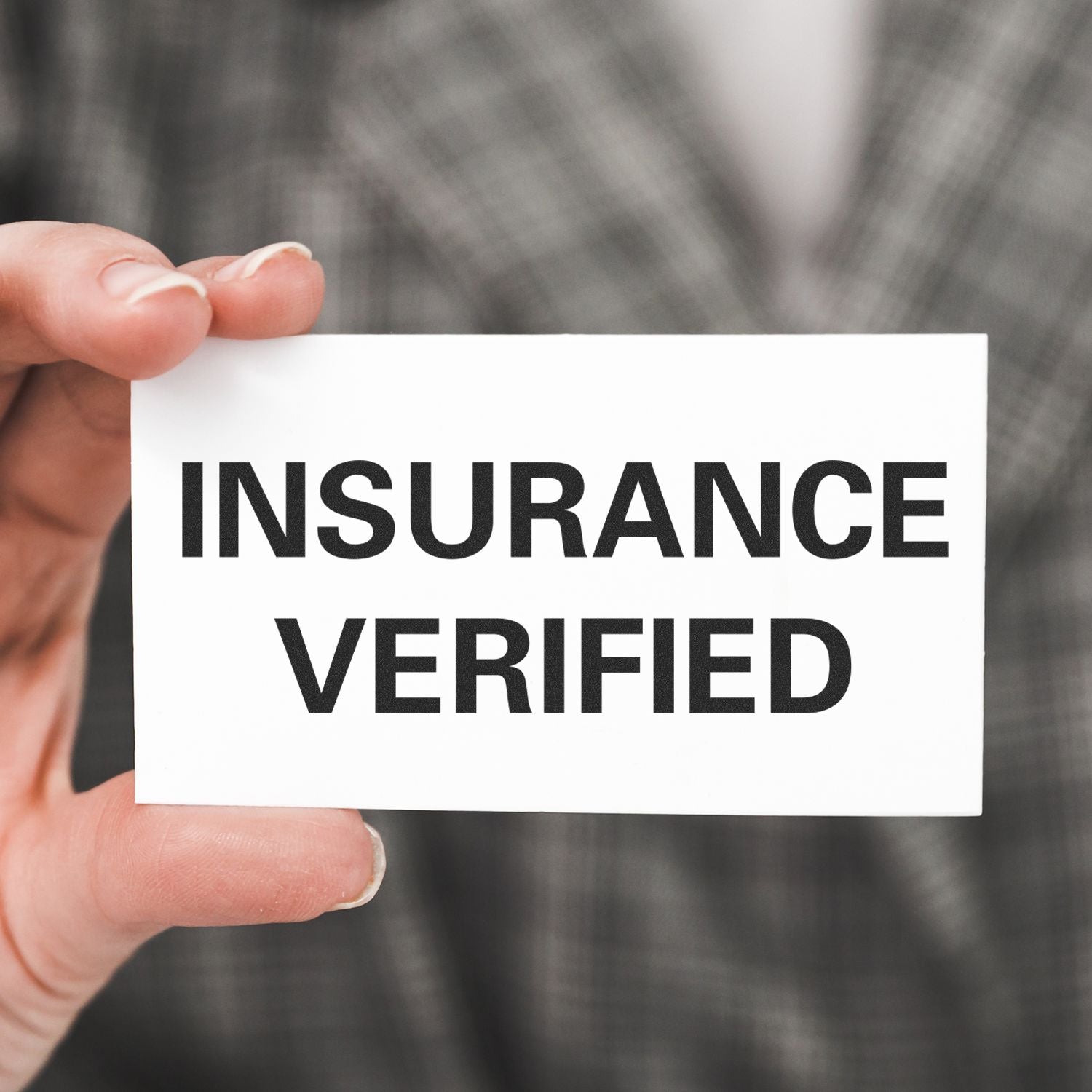 Hand holding card that reads Insurance Verified, signaling verified insurance coverage and authentication.