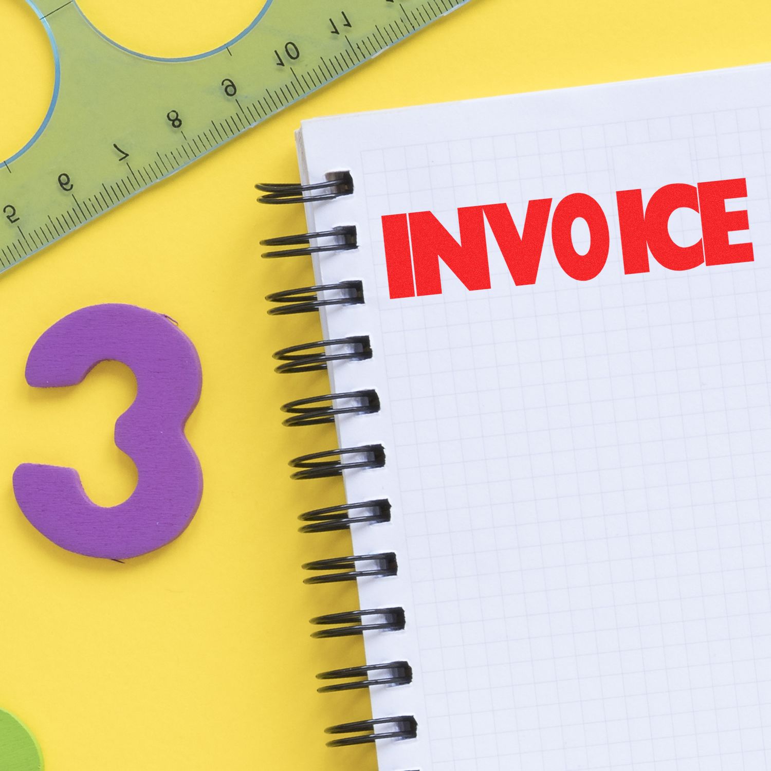 Invoice label on spiral notebook with ruler and question mark, representing billing, accounting, and invoice questions.