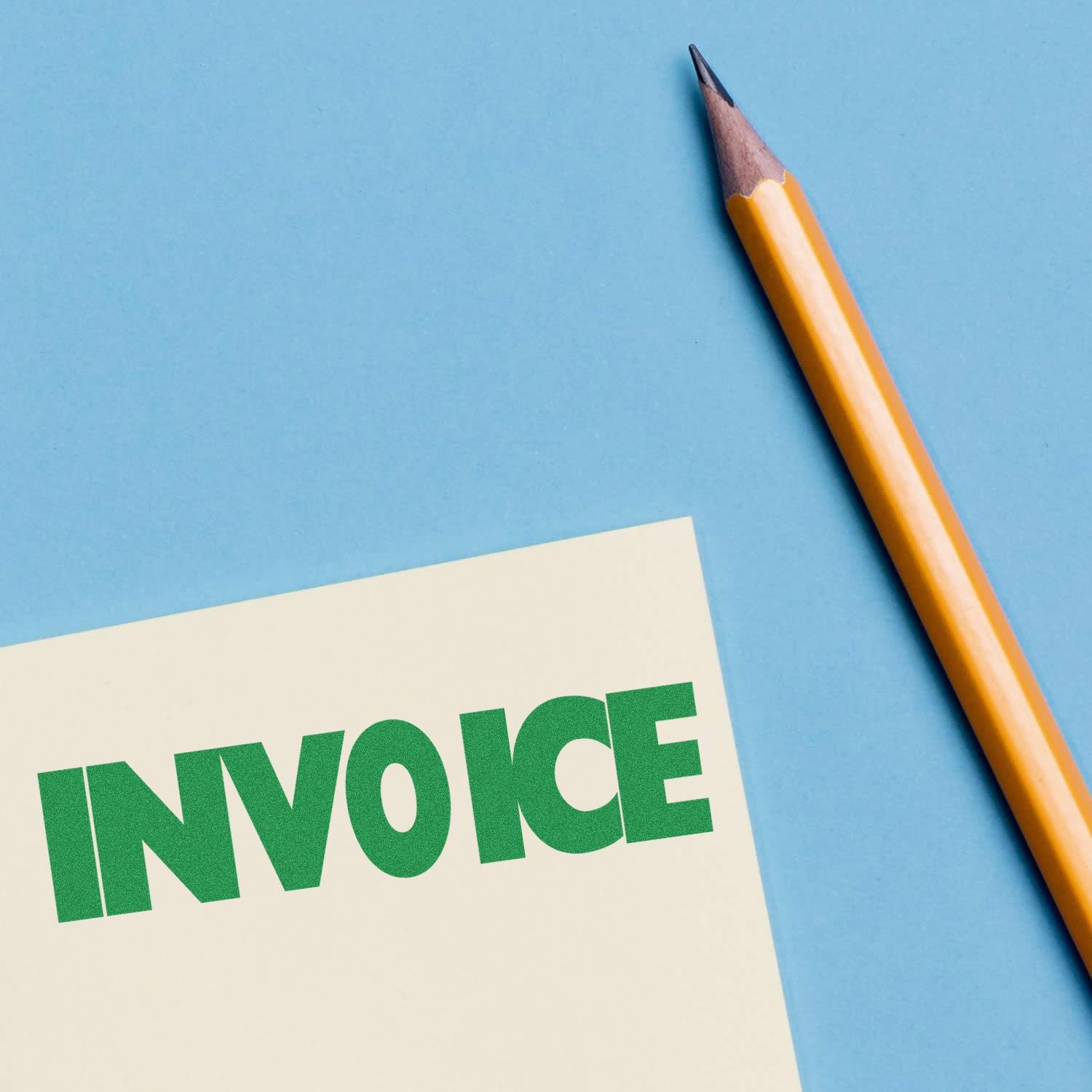Pencil beside an invoice paper on a blue background, symbolizing billing, accounting, and business paperwork.