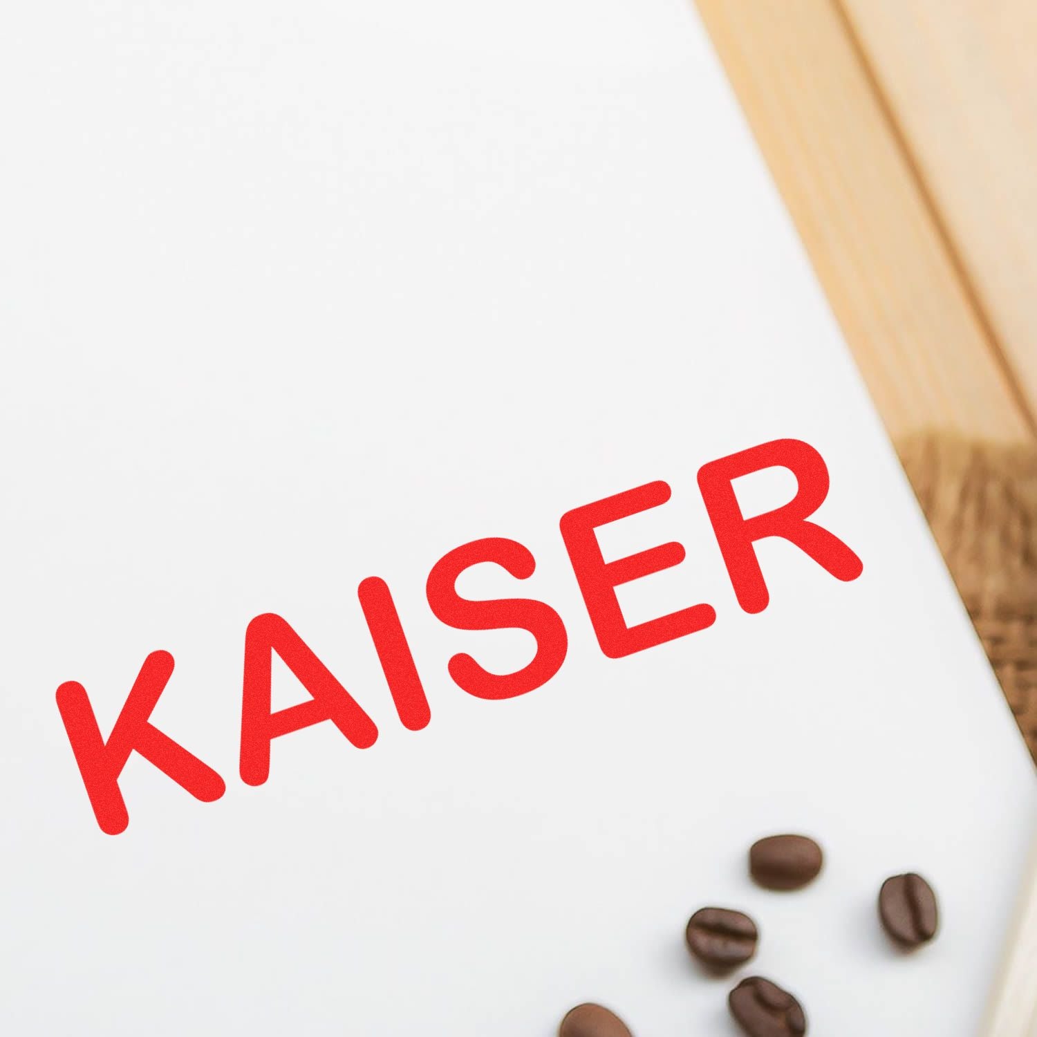 Kaiser coffee branding with red 'KAISER' logo, scattered coffee beans, and product packaging background for roasting and brewing.