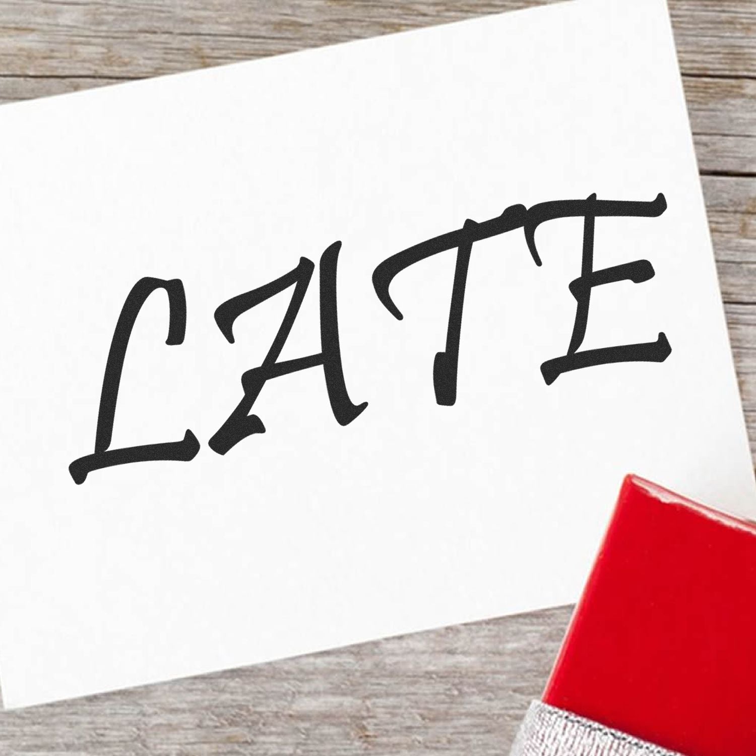Bold black brush-lettering typography on a white paper card on rustic wooden table, highlighting modern hand-lettering design.