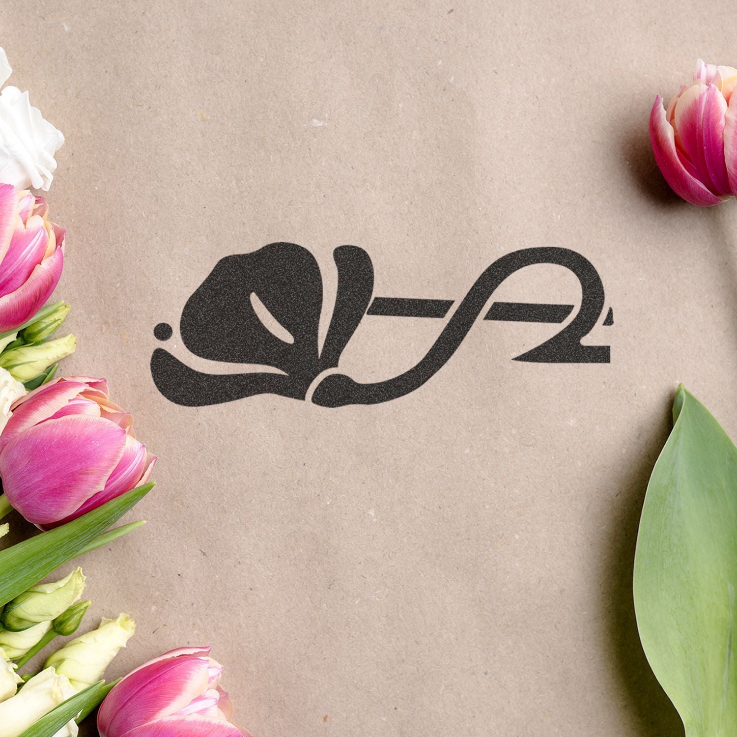 Pink and white tulips framing a rustic kraft paper background with a black elegant floral logo.