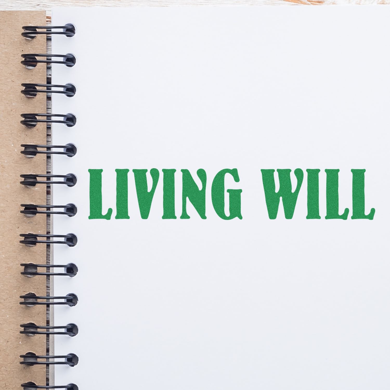 Notebook with motivational phrase LIVING WELL in green lettering, promoting healthy lifestyle and self-care wellness planning.