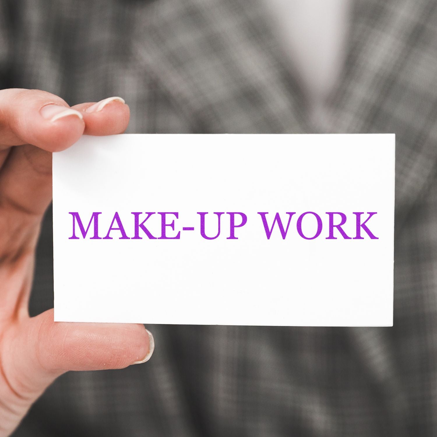 Hand holds card reading MAKE-UP WORK, a reminder to complete missed assignments and school makeup work.