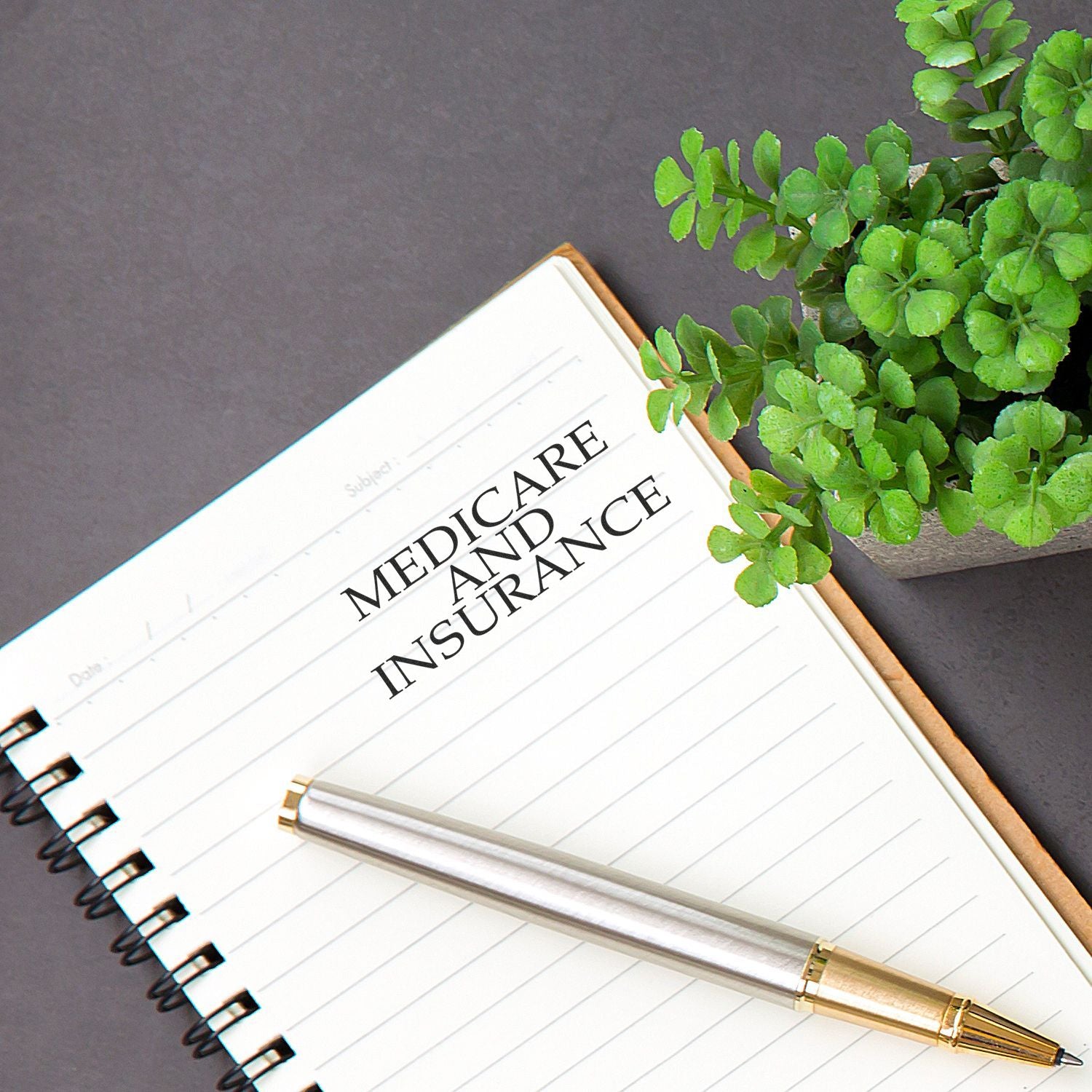Medicare and future insurance planning concept on notebook with pen and green leaves, supporting healthcare readiness and coverage goals