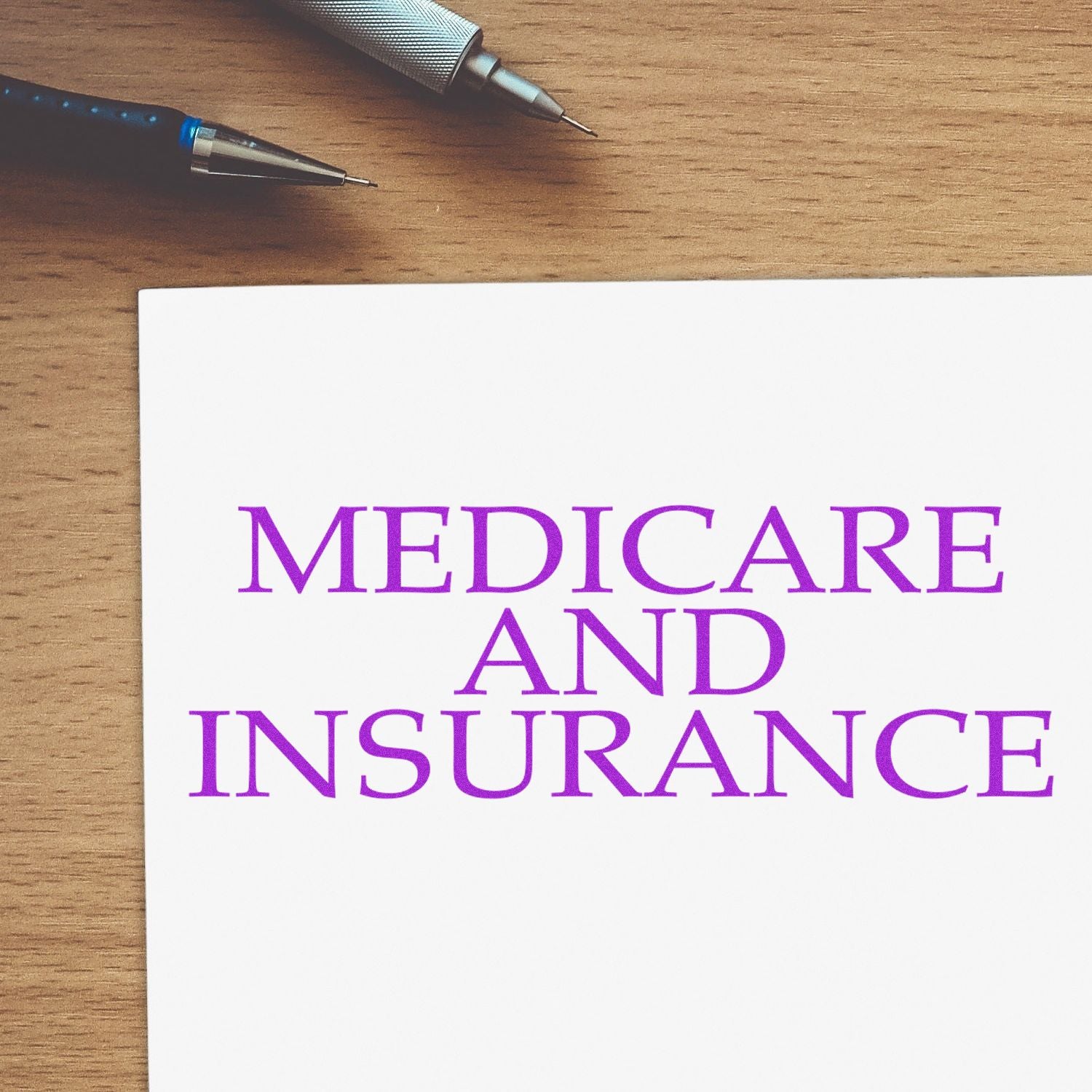 Pens on a wooden desk next to a card reading Medicare and Insurance, promoting health coverage information.