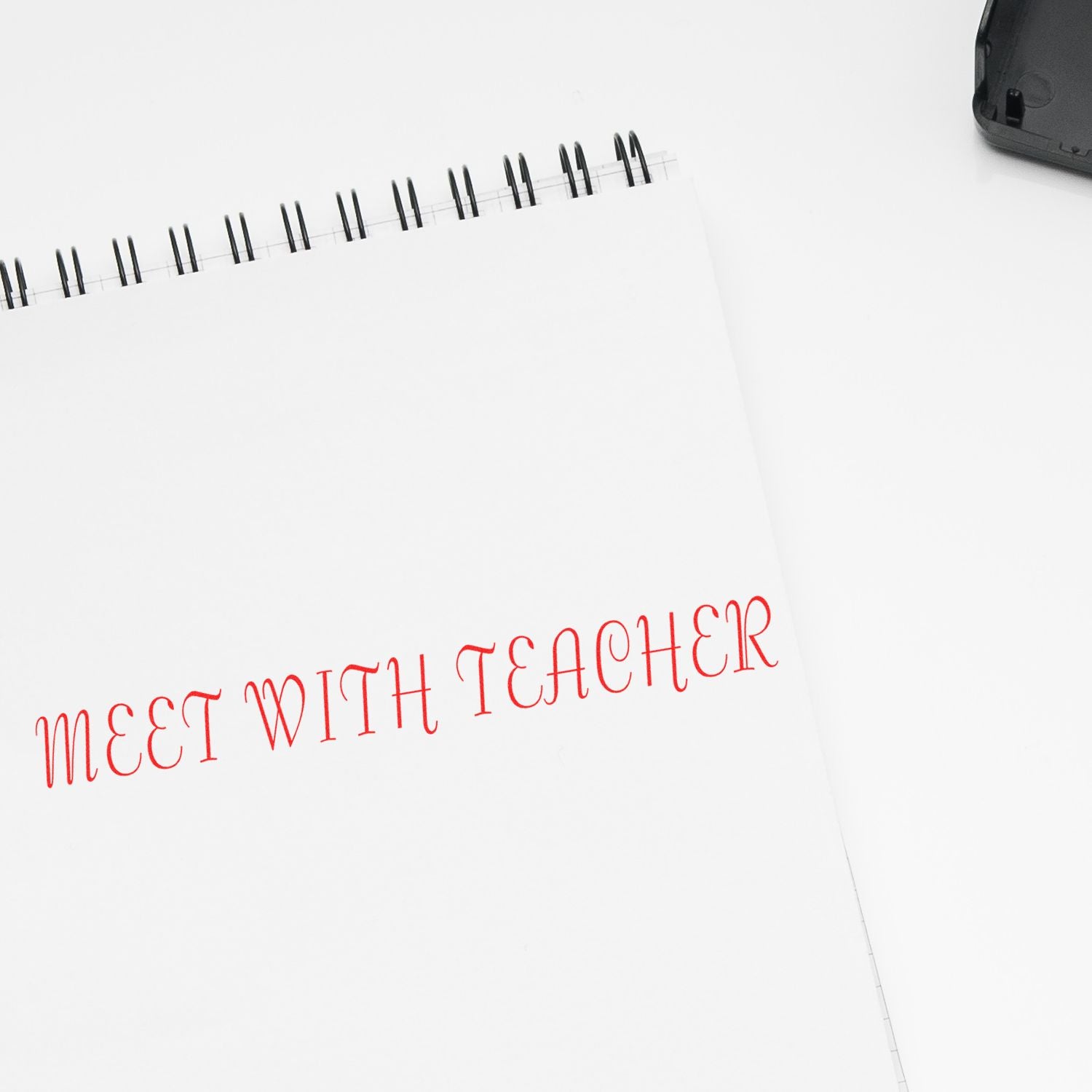 Planner notebook page with handwritten reminder Meet with Teacher, showing upcoming school meeting scheduling and appointments.