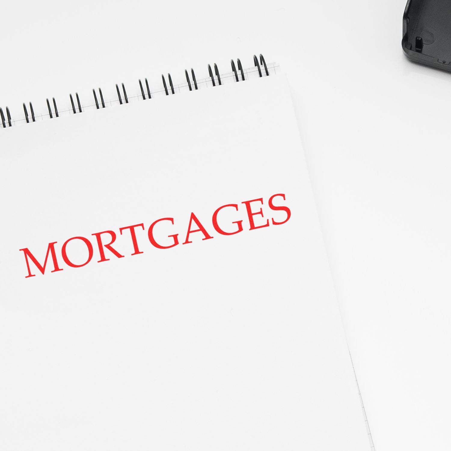 Close-up of a spiral notebook page labeled Mortgages, symbolizing mortgage planning and home loan research.