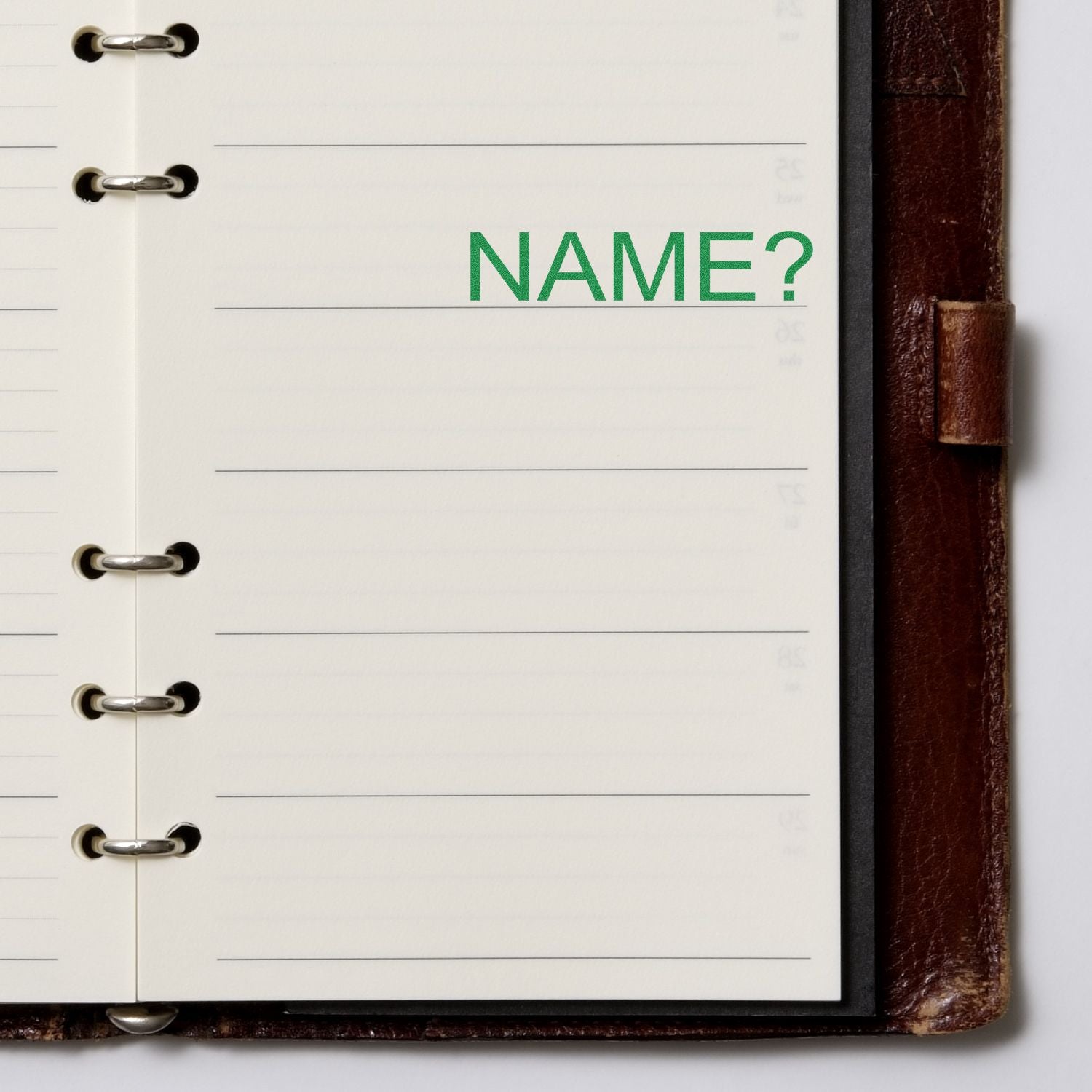 Notebook page with green NAME? prompt, blank space to enter your name for personal details or registration.