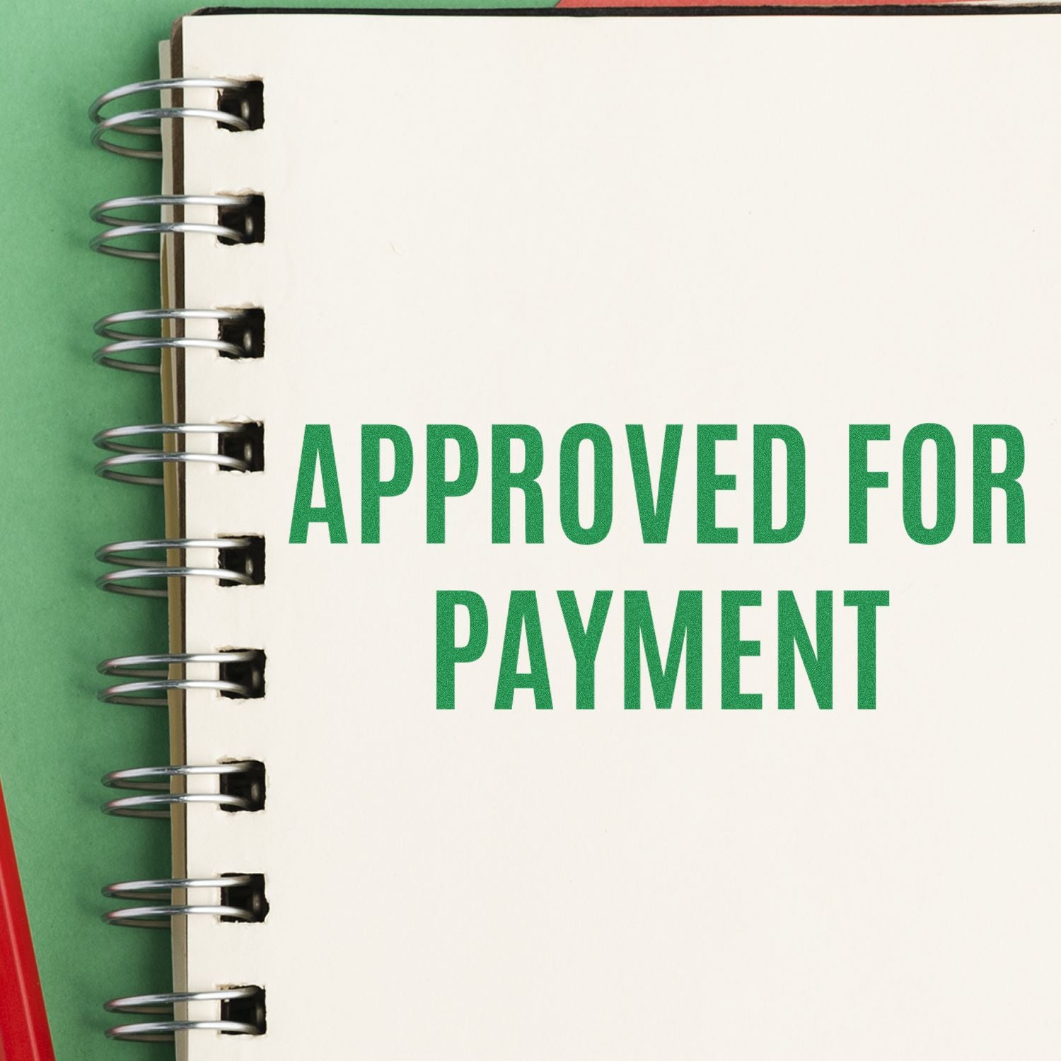 Approved for Payment stamp on spiral notebook, indicating invoice approval and payment processing documentation.
