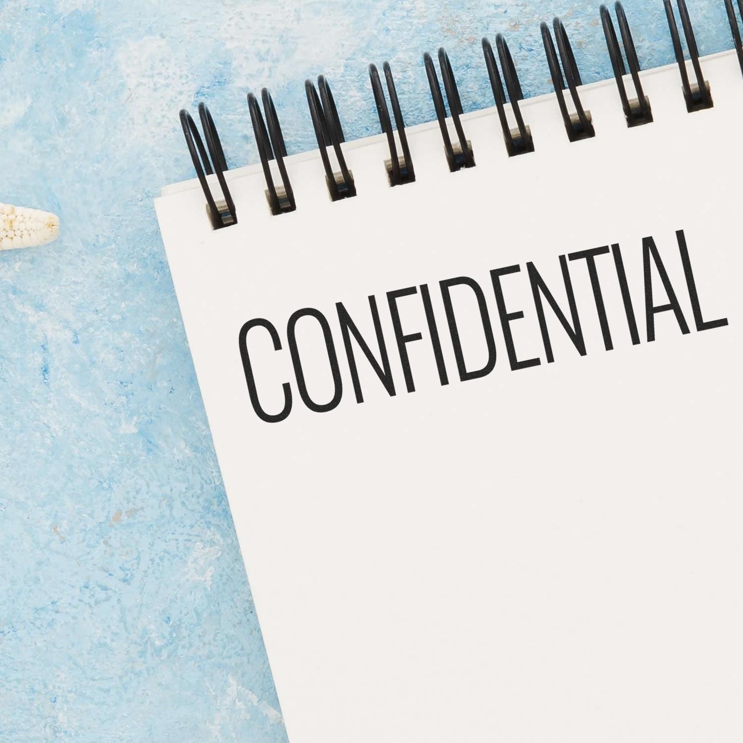 Confidential document with binder clips showing CONFIDENTIAL, emphasizing data privacy and secure information handling