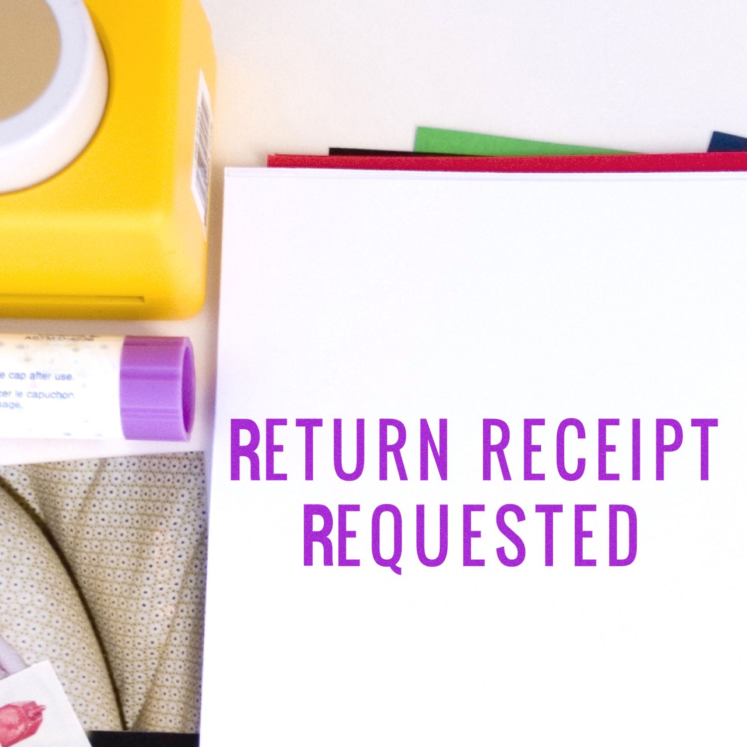 Return receipt requested form with office supplies and packaging materials on a white background.