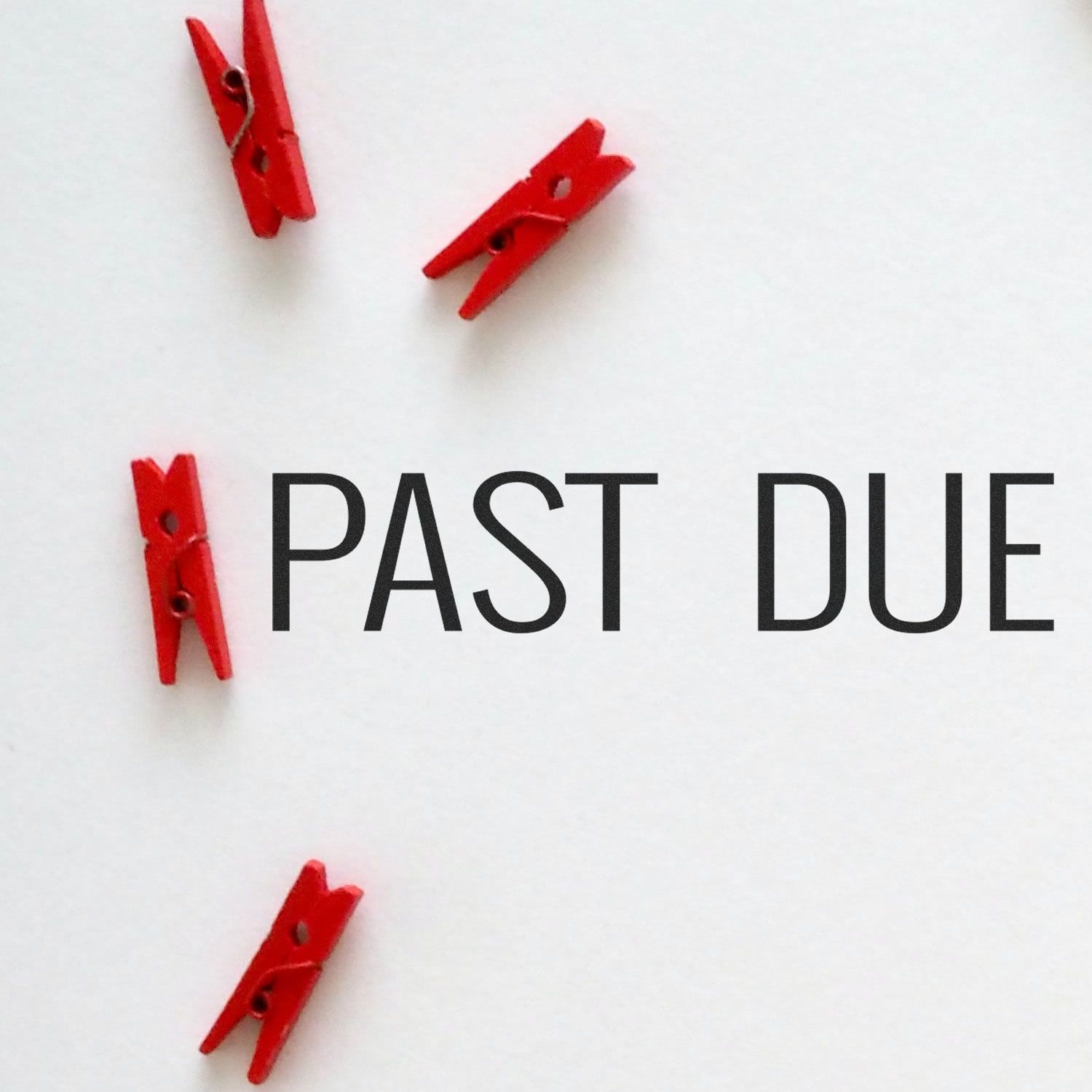 Past due reminder with red clothespins and bold PAST DUE text on white background, symbolizing overdue payments and deadlines.