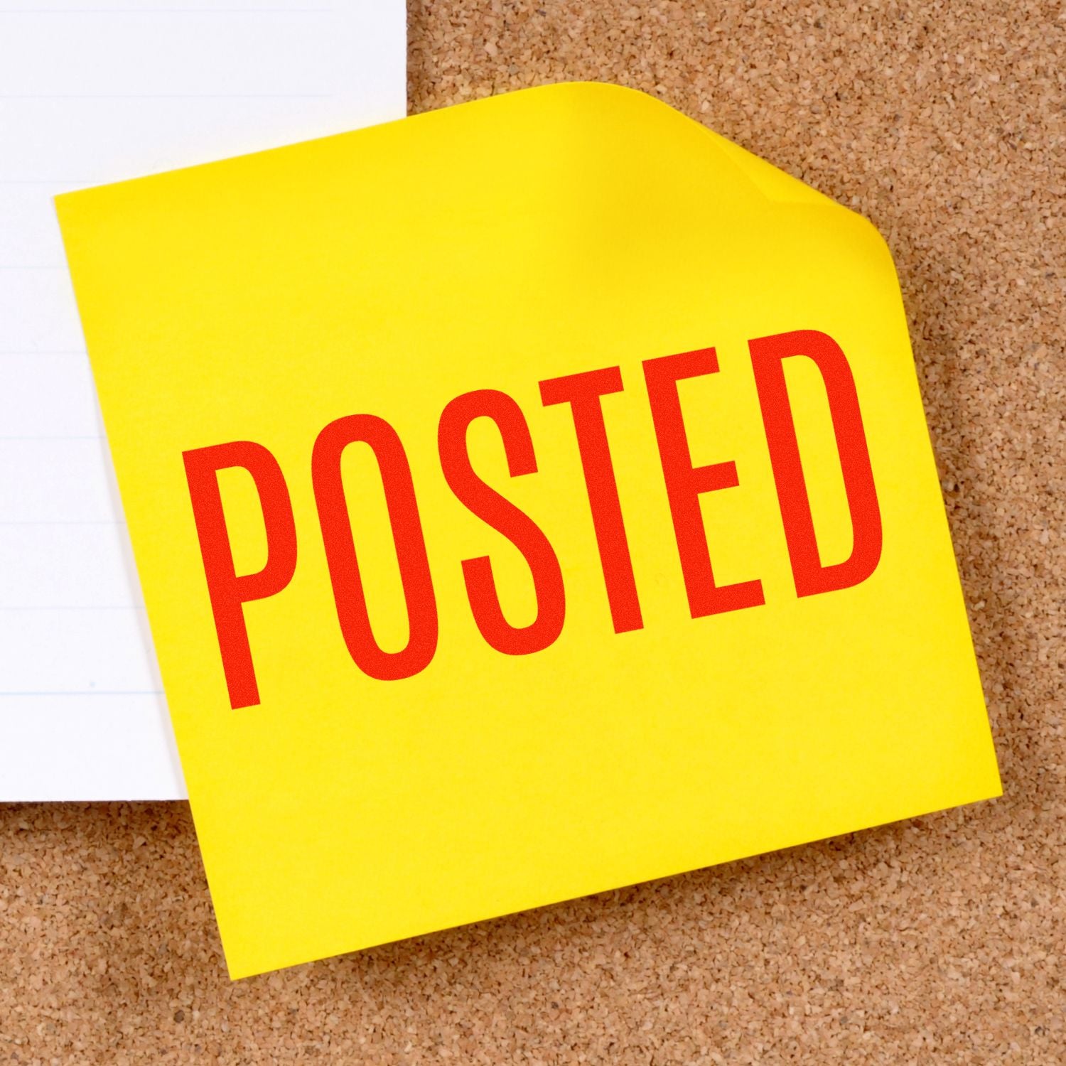 Yellow sticky note on cork board reading POSTED, used to announce updates or information.