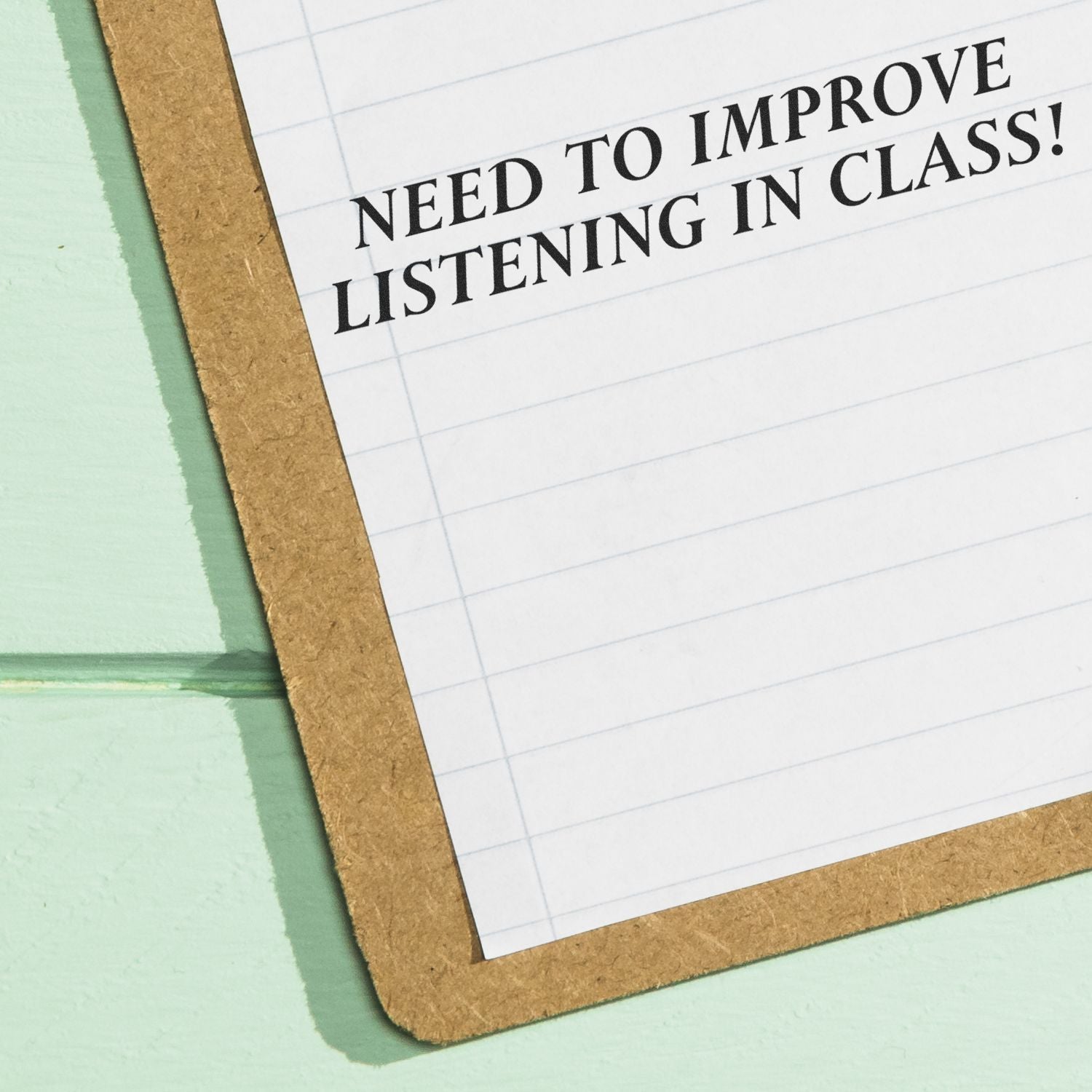 Clipboard with note reading Need to Improve Listening in Class, educational classroom feedback concept.