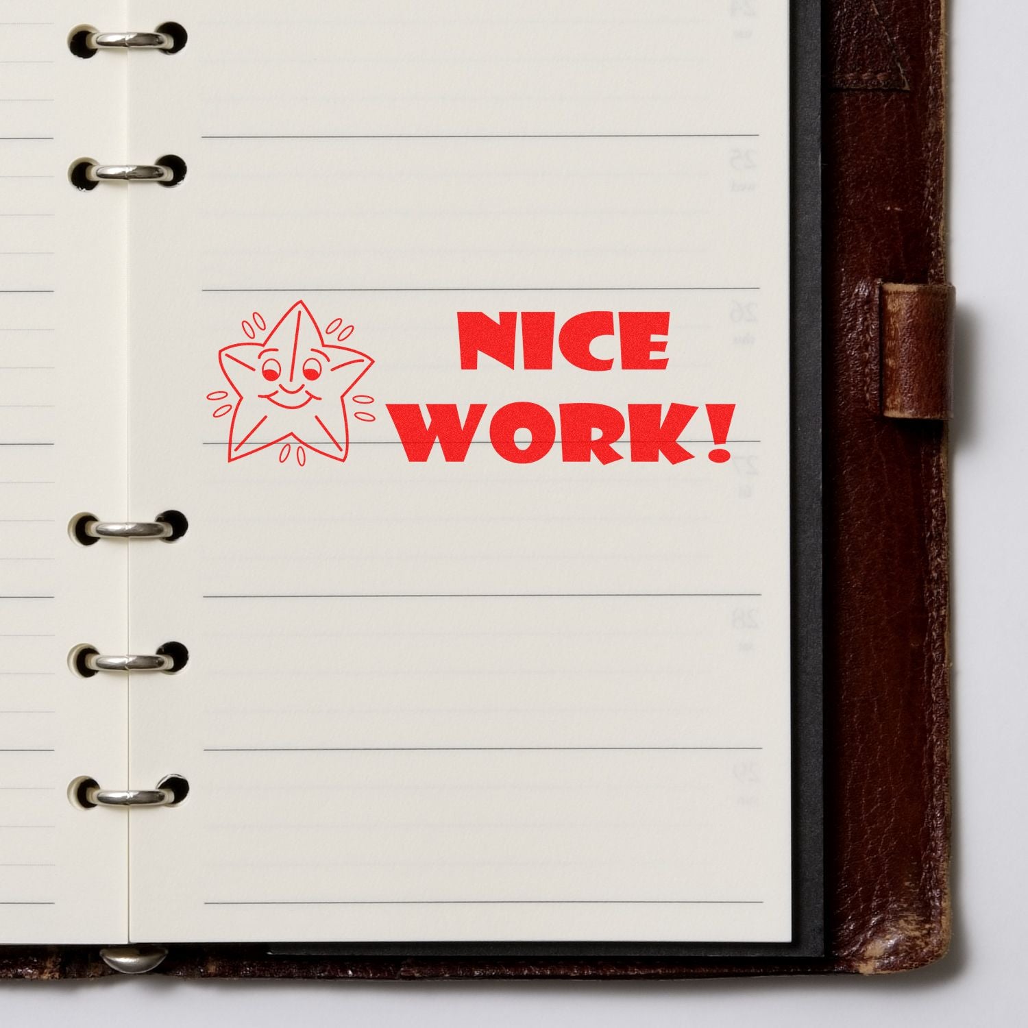 Notebook page with red NICE WORK! message and smiling star doodle, expressing positive teacher feedback.