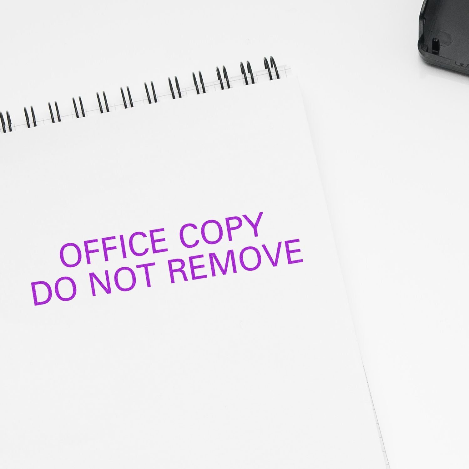 Office copy label on a notebook reading Do not remove, indicating restricted document handling.