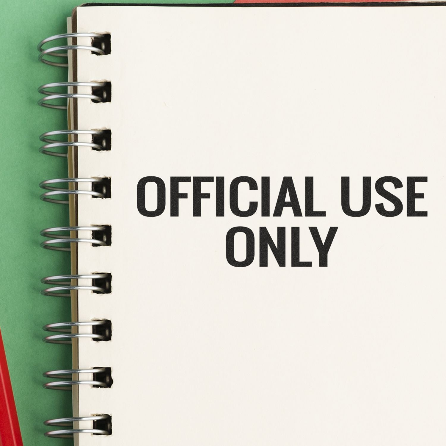 Spiral-bound notebook with blank page labeled Official Use Only on a green background.