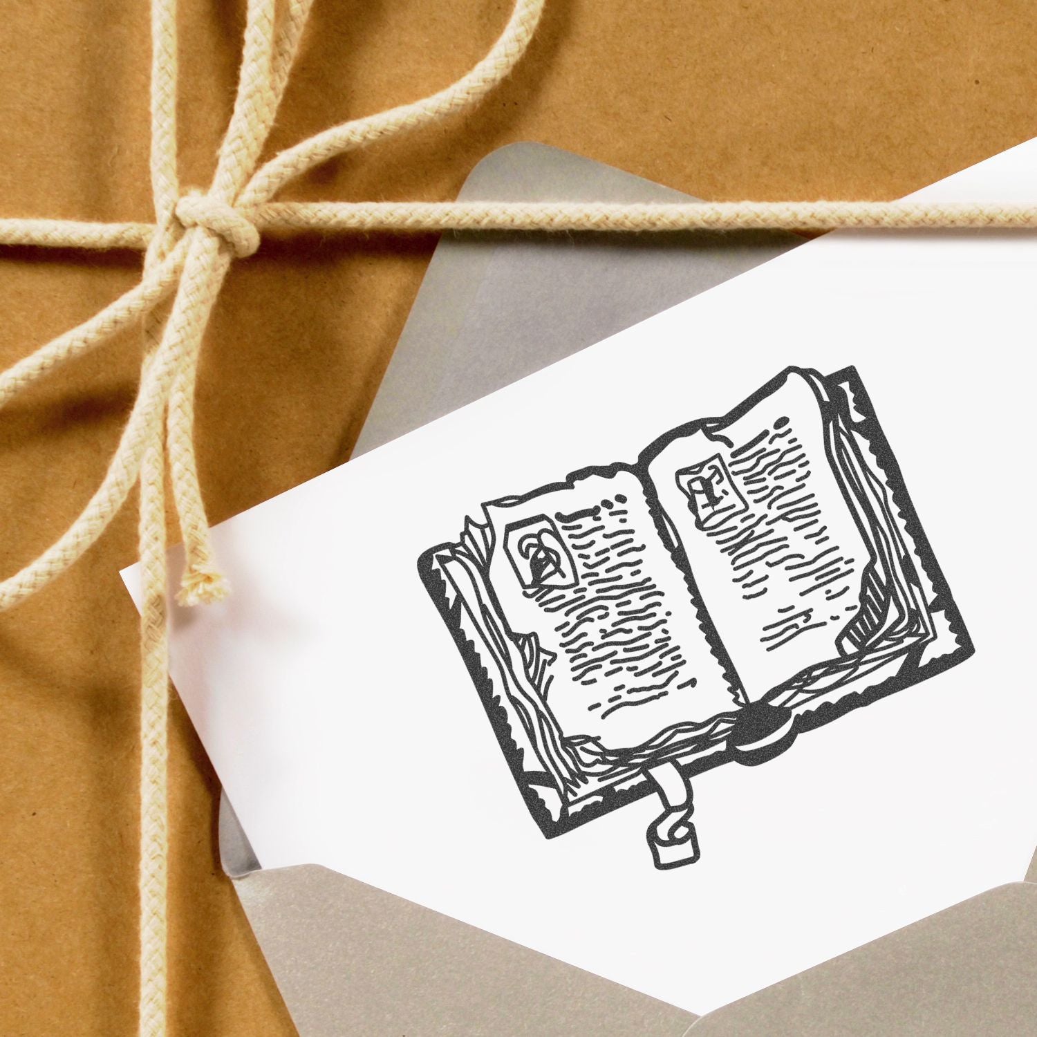 Eco-friendly kraft paper gift wrapped with twine and a book illustration card, ideal for literary gift packaging.