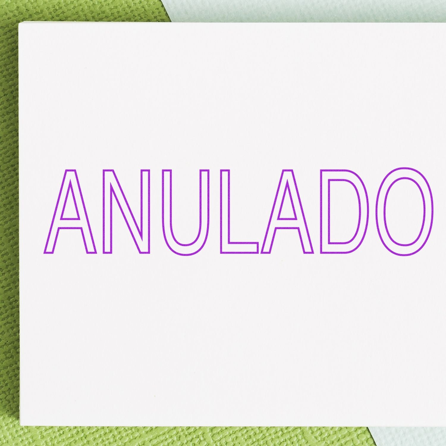 Anulado stamp text on white card, indicating a canceled or voided document (ANULADO) over green background.