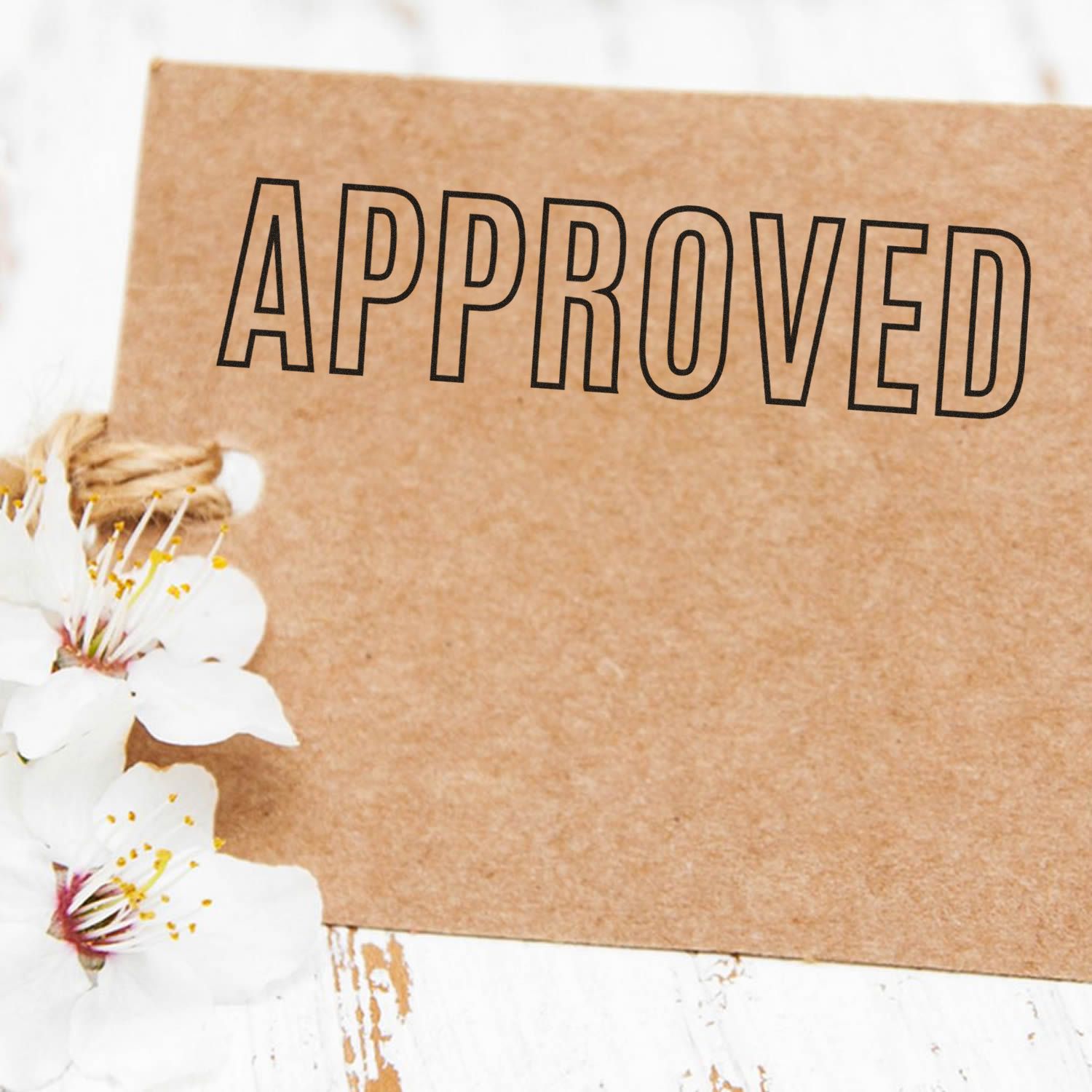 Approved stamp on kraft paper with white flowers, rustic business concept background