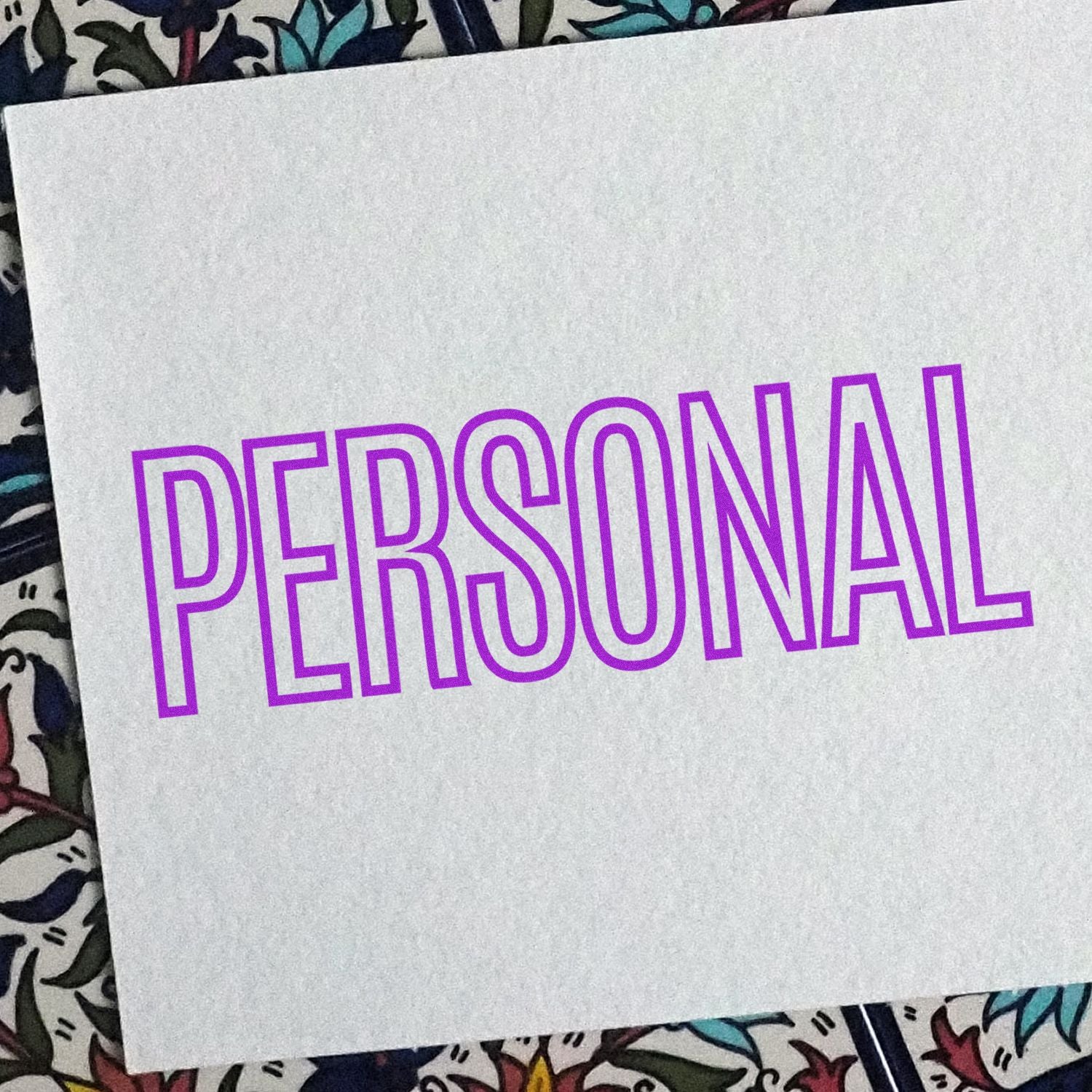 Purple PERSONAL typography design on white fabric, ideal for personalized apparel or stationery.
