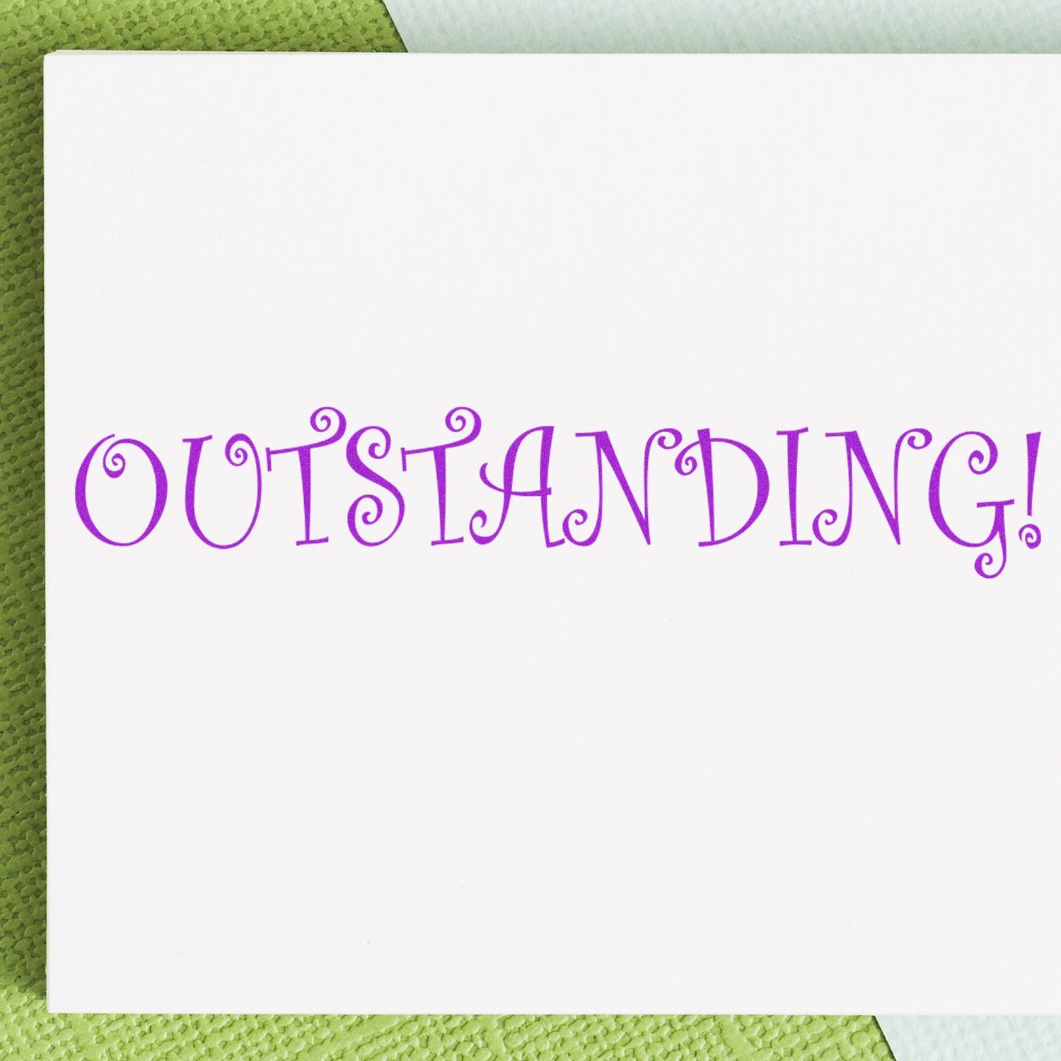 Motivational greeting card reading Outstanding! in purple decorative lettering on textured green background.