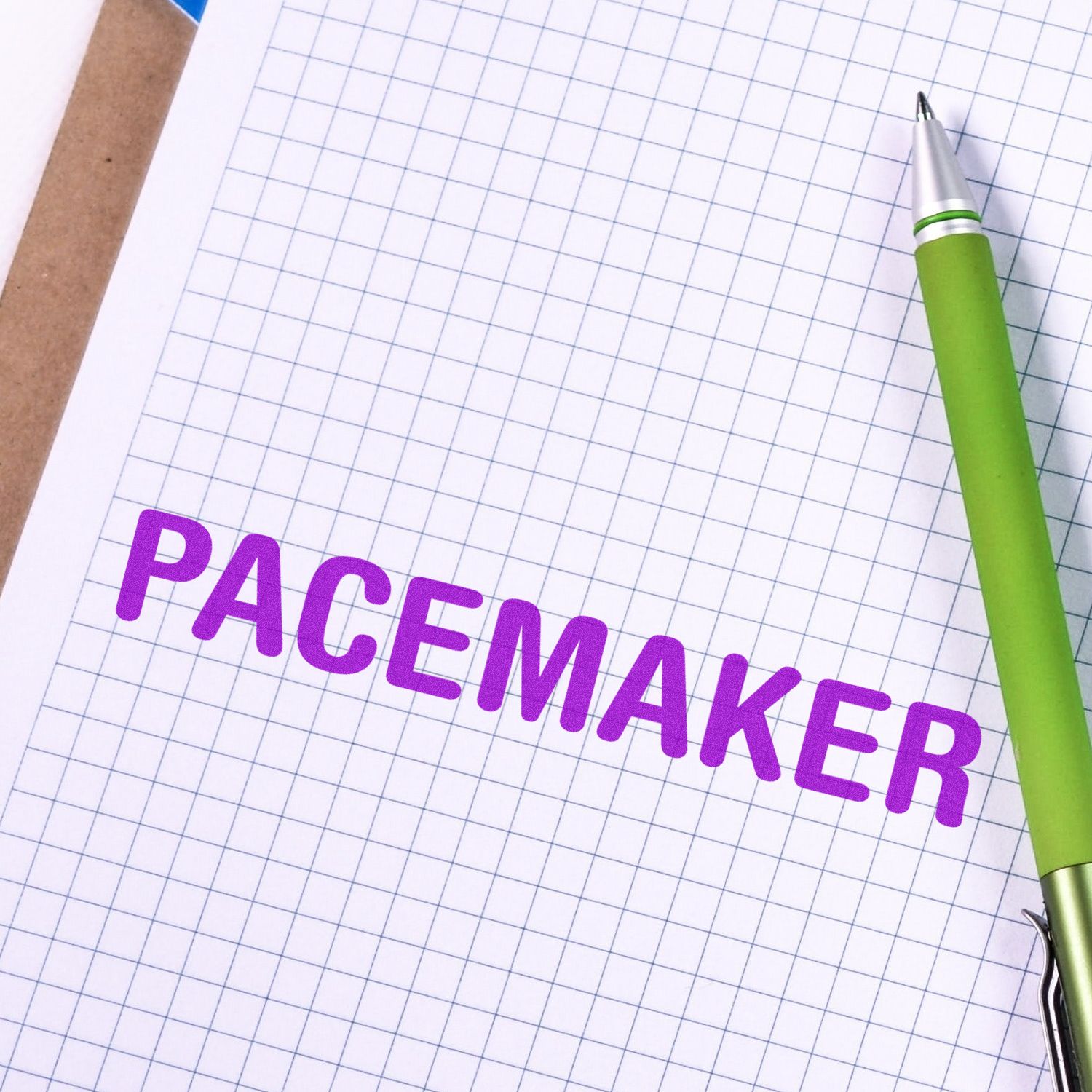 Graph paper with green pen and Pacemaker text, suggesting pacemaker planning, education, and medical device research.