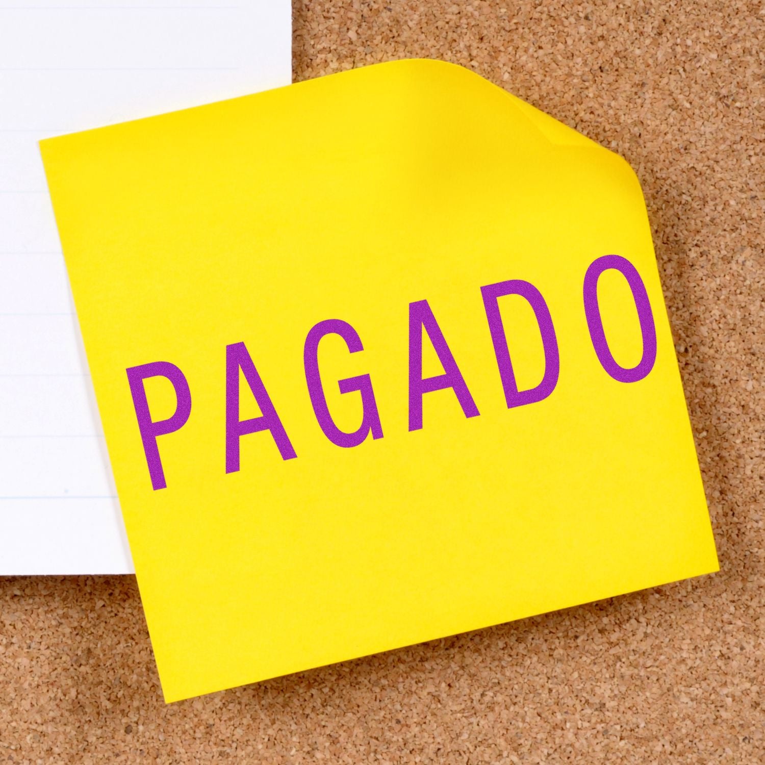 Yellow sticky note on corkboard reading PAGADO (paid), confirming payment status