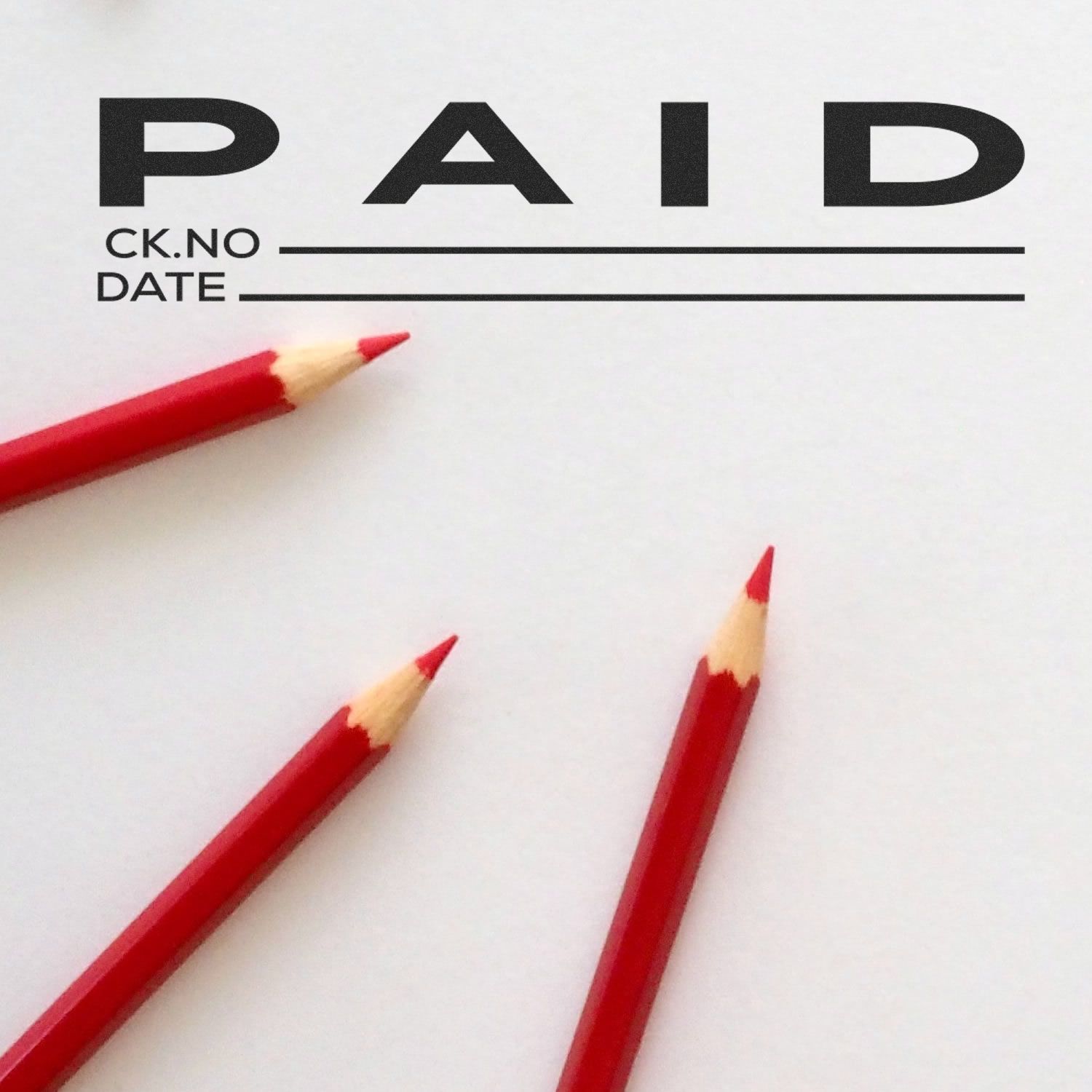 Blank paid invoice form with red pencils, business accounting and payment concept.