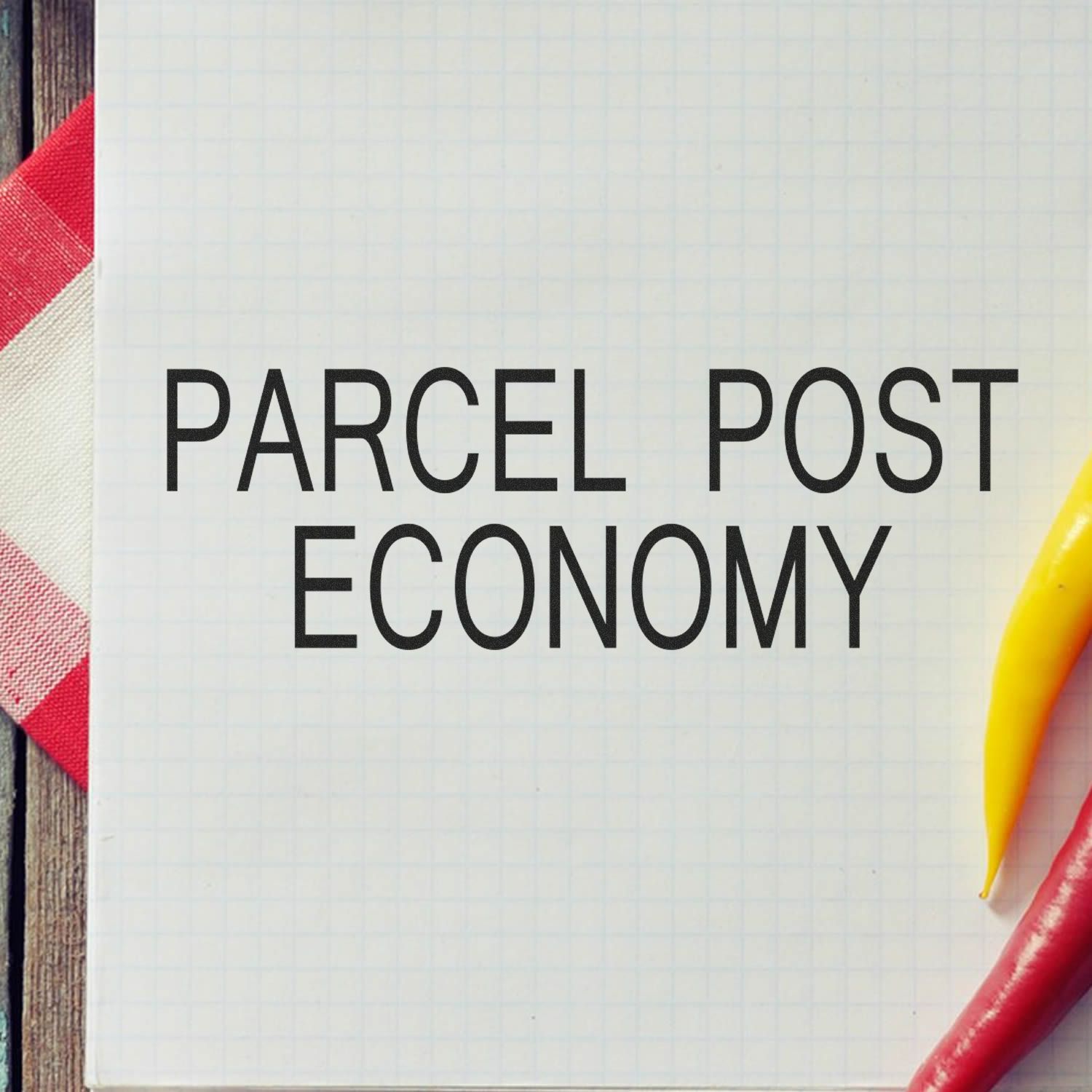 Parcel post economy text on notebook paper with colorful pens, representing postal shipping and delivery costs.