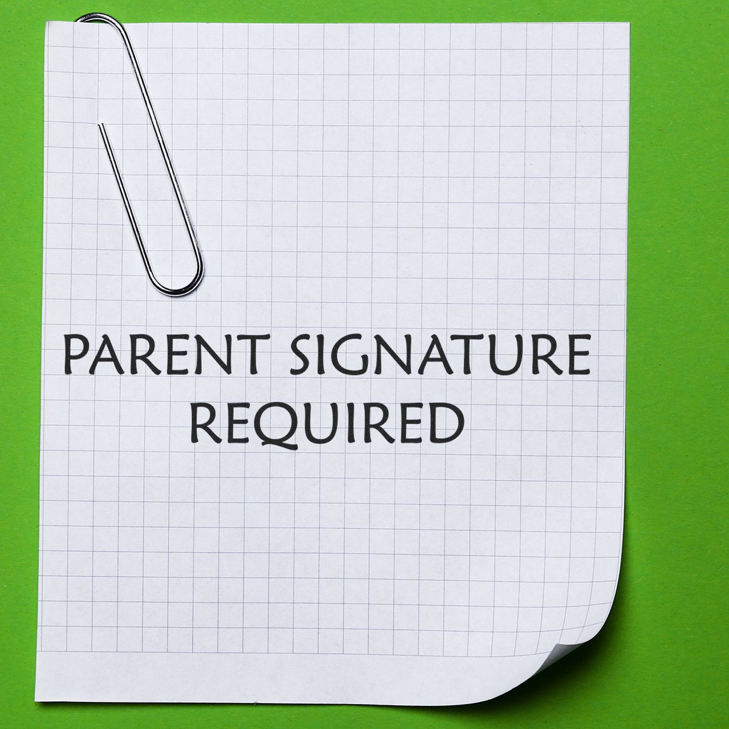 Parent signature required on lined permission form with paperclip, used for school consent and approval paperwork submission.